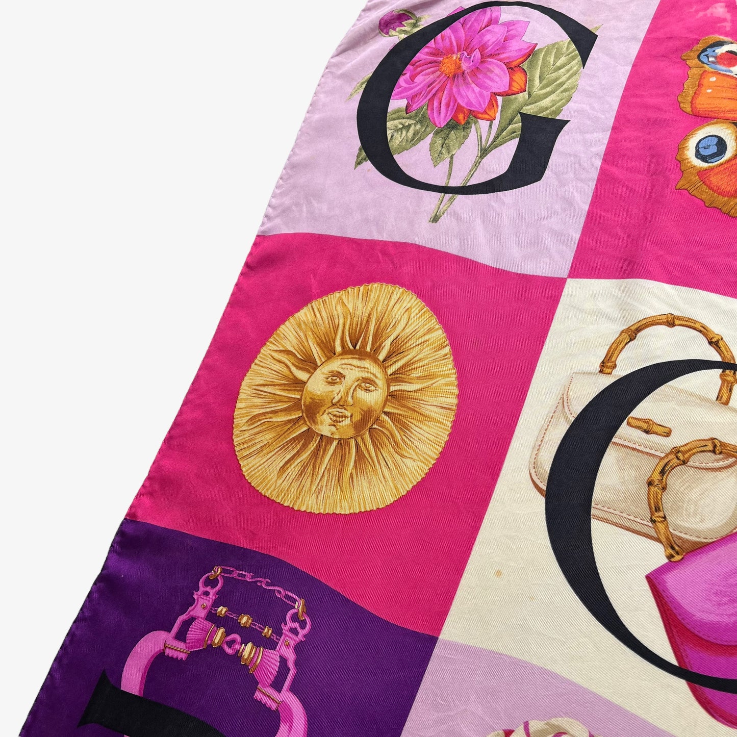 Sun face pattern of women's vintage 90s Gucci geometric patchwork checkered spell out print pink silk scarf.