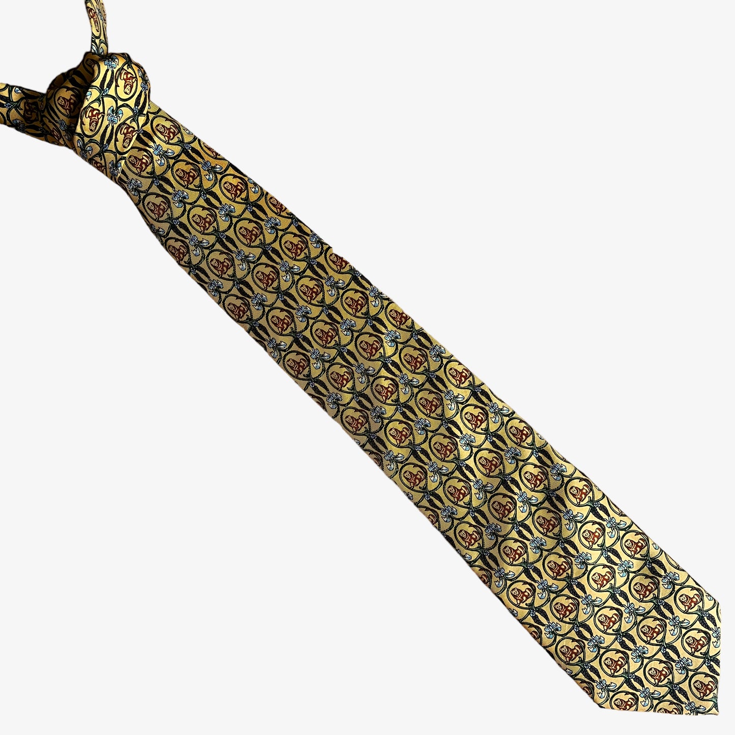 A vintage 90s ING Bank lion silk tie with a geometric pattern in yellow, showing signs of wear.