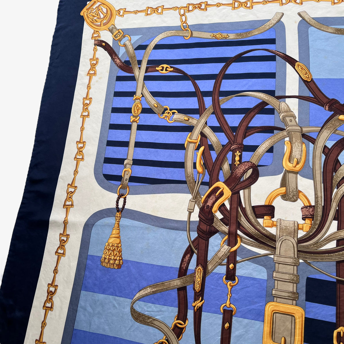 Equestrian buckle on women's vintage 90s Lancel Paris gold horsebit print blue silk scarf featuring a striped design.