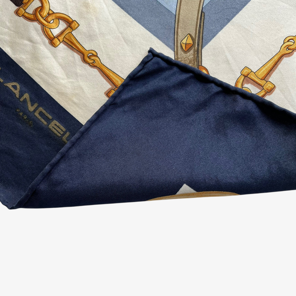 Hand rolled edges on women's vintage 90s Lancel Paris gold equestrian horsebit print blue silk scarf featuring a striped design.