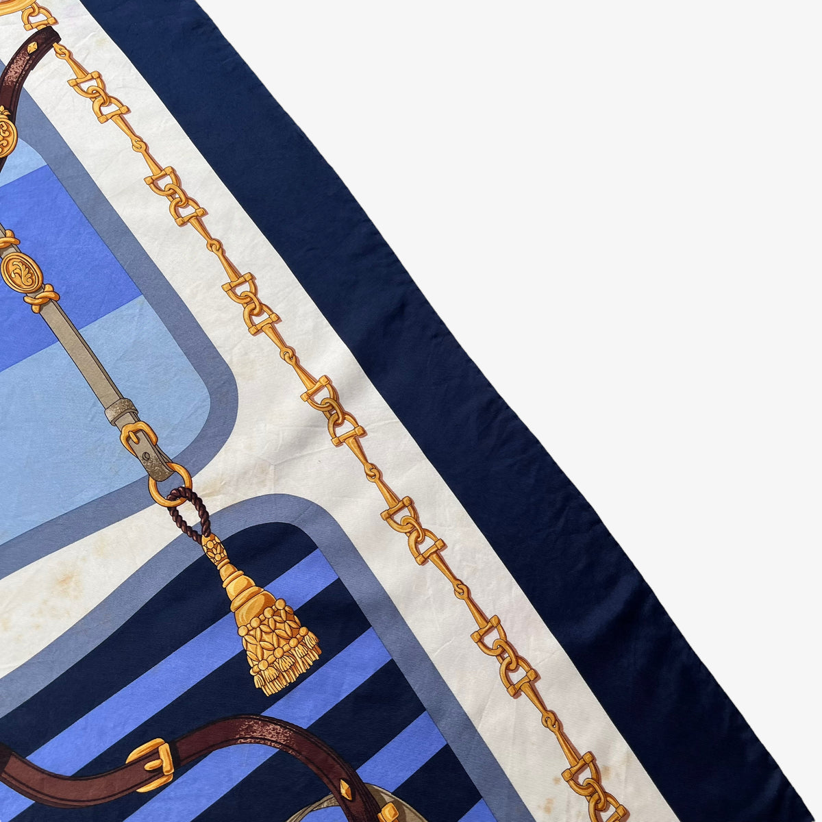 Patina on women's vintage 90s Lancel Paris gold equestrian horsebit print blue silk scarf featuring a striped design.