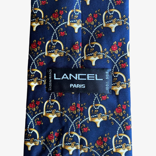 Label of vintage 90s Lancel Paris horsebit and floral geometric print silk tie.
