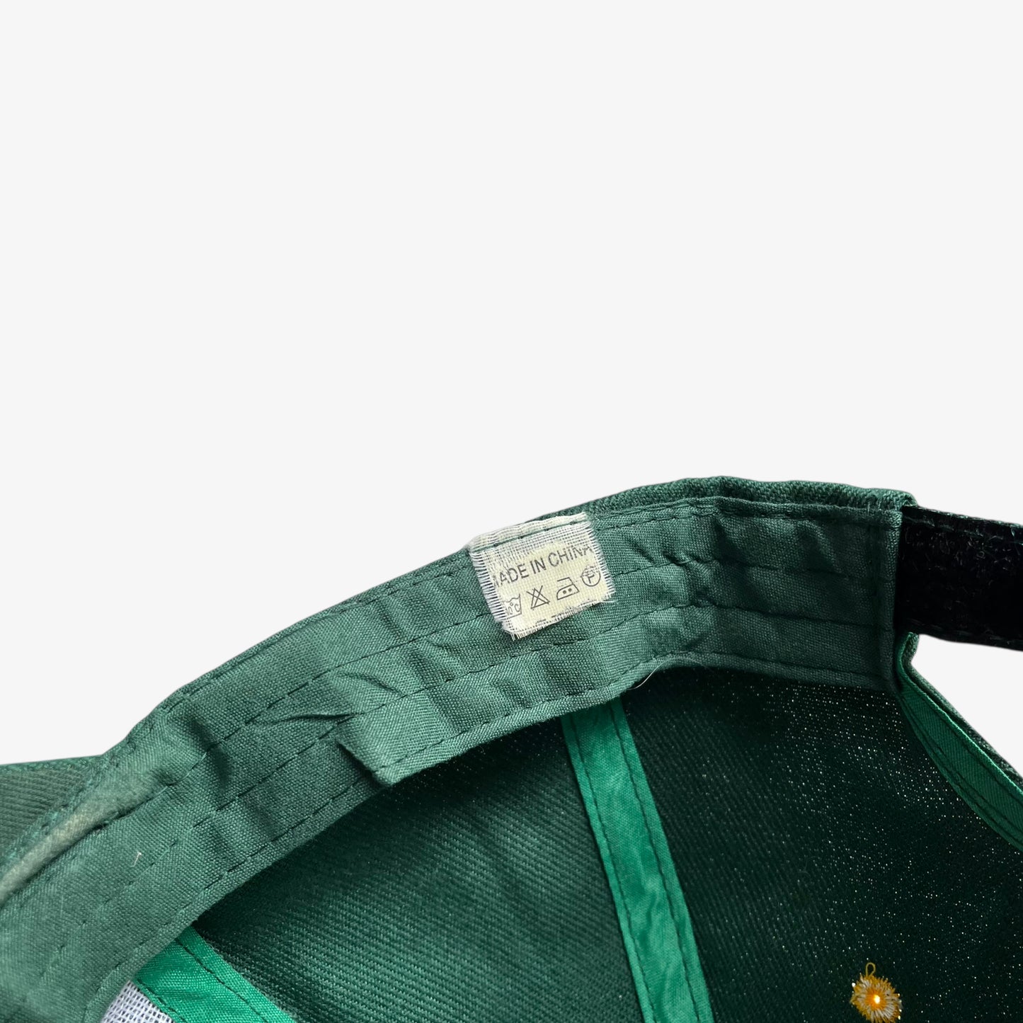 Label stitched inside of vintage 90s Land Rover embroidered green cap.