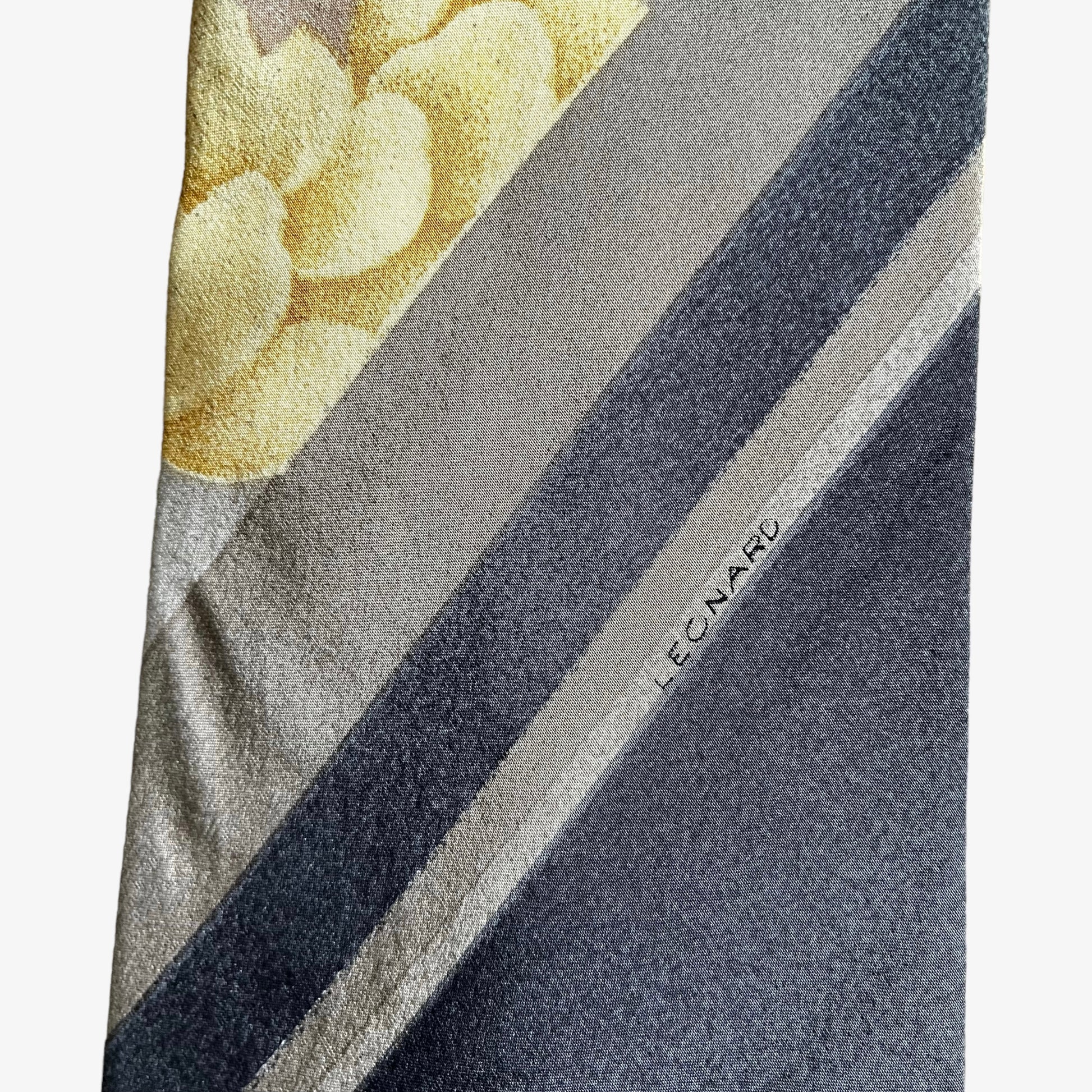 Close up of logo on vintage 90s Leonard striped abstract floral print silk tie.