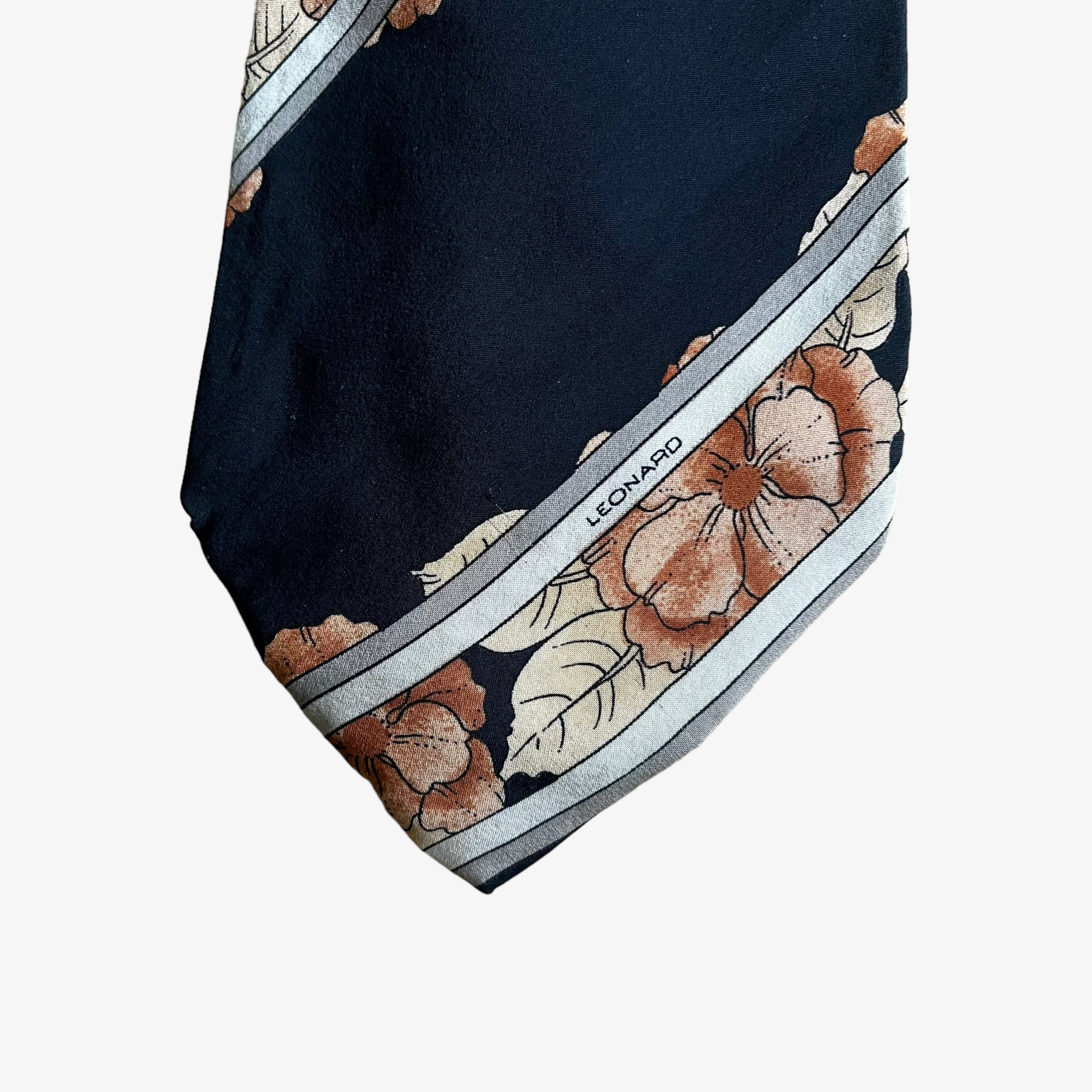 Close up of logo on vintage 90s Leonard striped floral print silk tie.