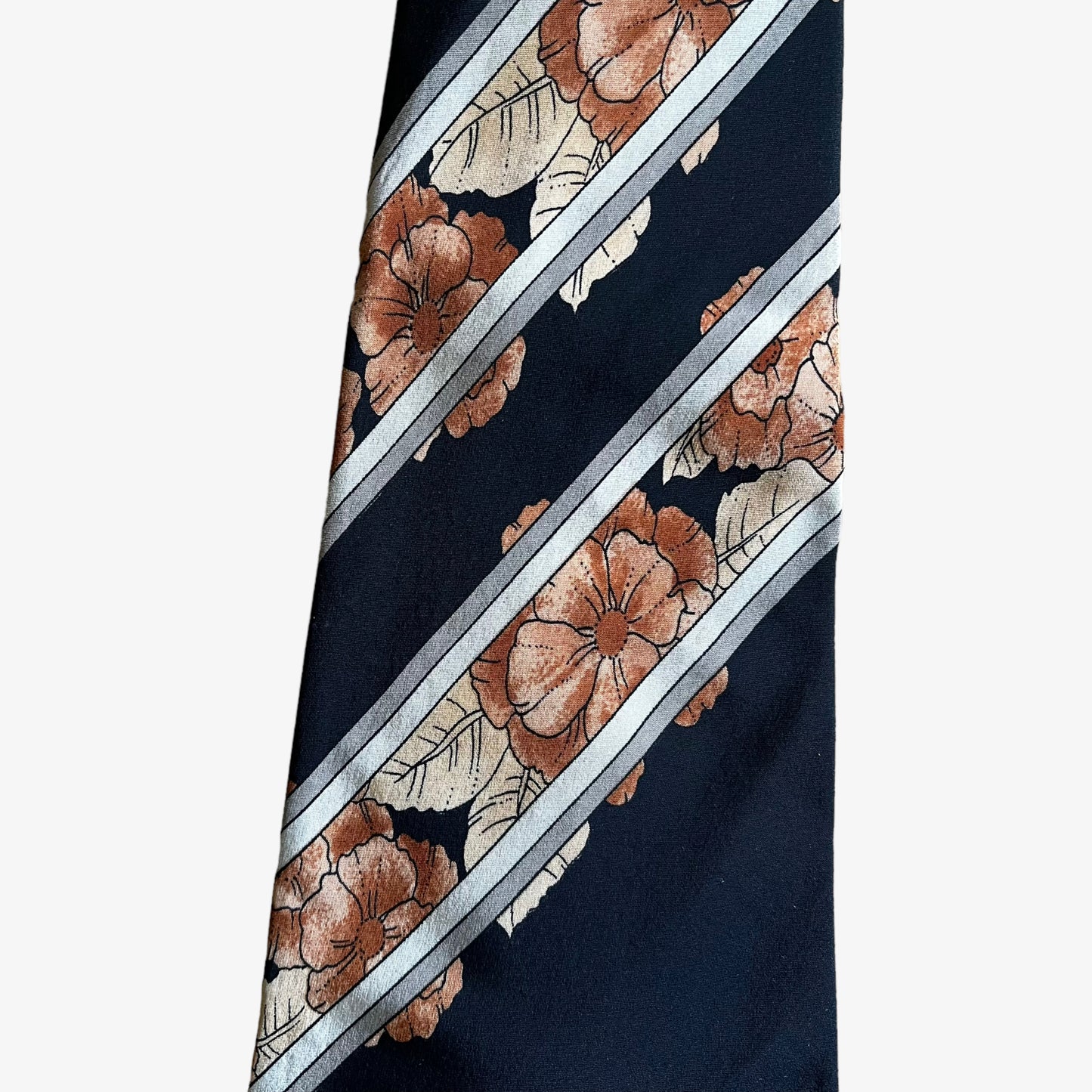 Close up of pattern on vintage 90s Leonard striped floral print silk tie.