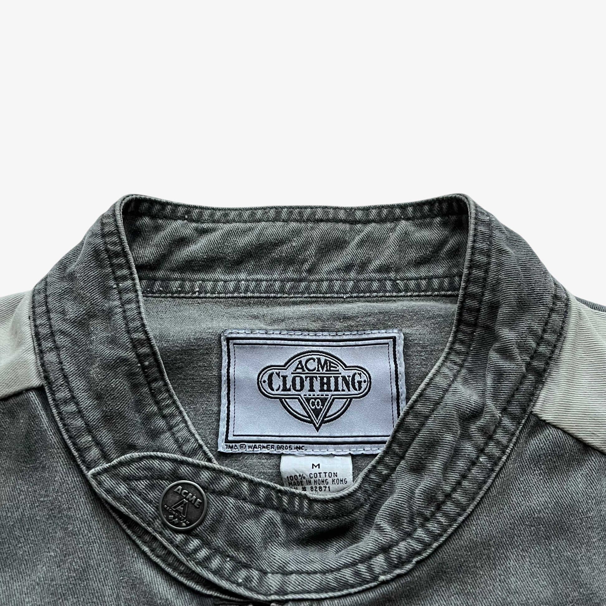ACME clothing label stitched inside of a vintage 90s men's Warner Bros Looney Tunes Bugs Bunny grey NASCAR jacket.