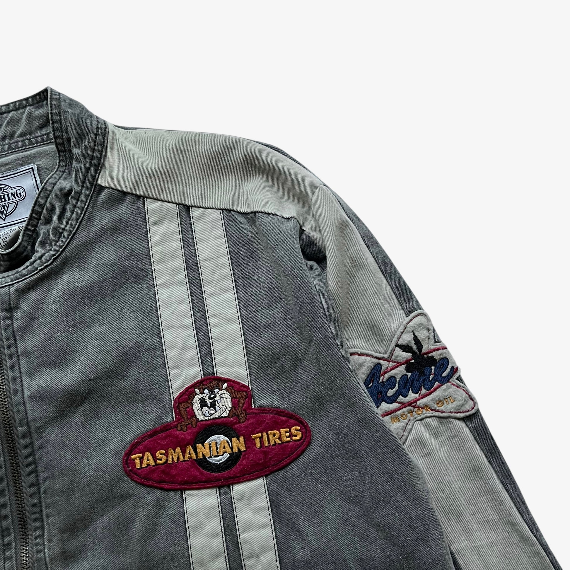 Close up of an embroidered Tasmanian Devil badge on a vintage 90s men's ACME Warner Bros Looney Tunes Bugs Bunny grey NASCAR jacket.