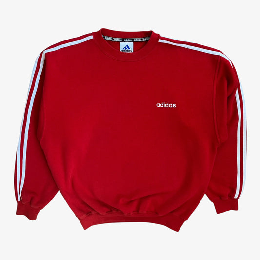 Red Adidas sweatshirt with an embroidered spell out and white stripe arms.