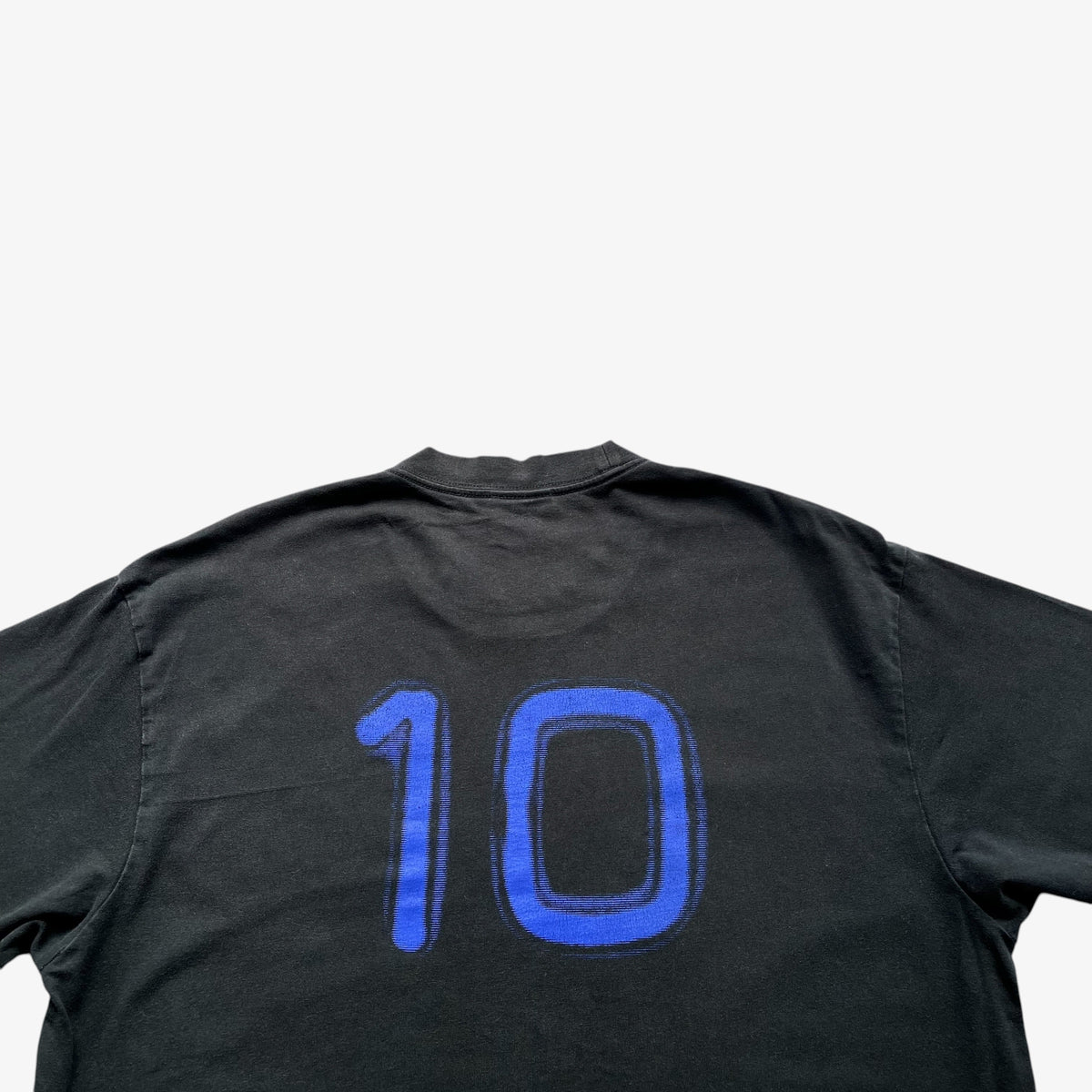 A vintage Adidas black short-sleeve t-shirt shown from the back, featuring the number '10' printed in a blue gradient with a black outline.