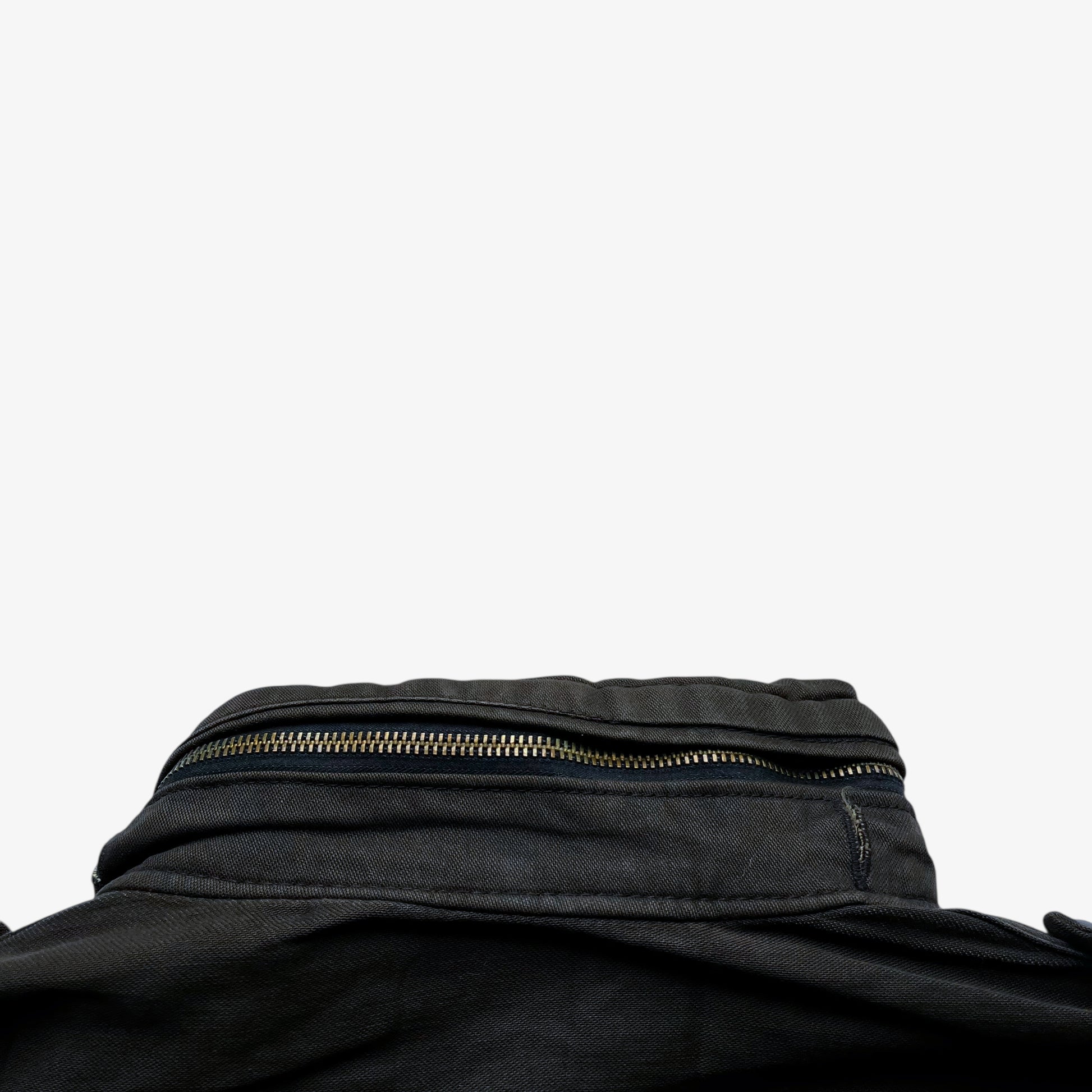 Foldable hood of vintage 90s men's Alpha Industries brown M65 cold weather field jacket.