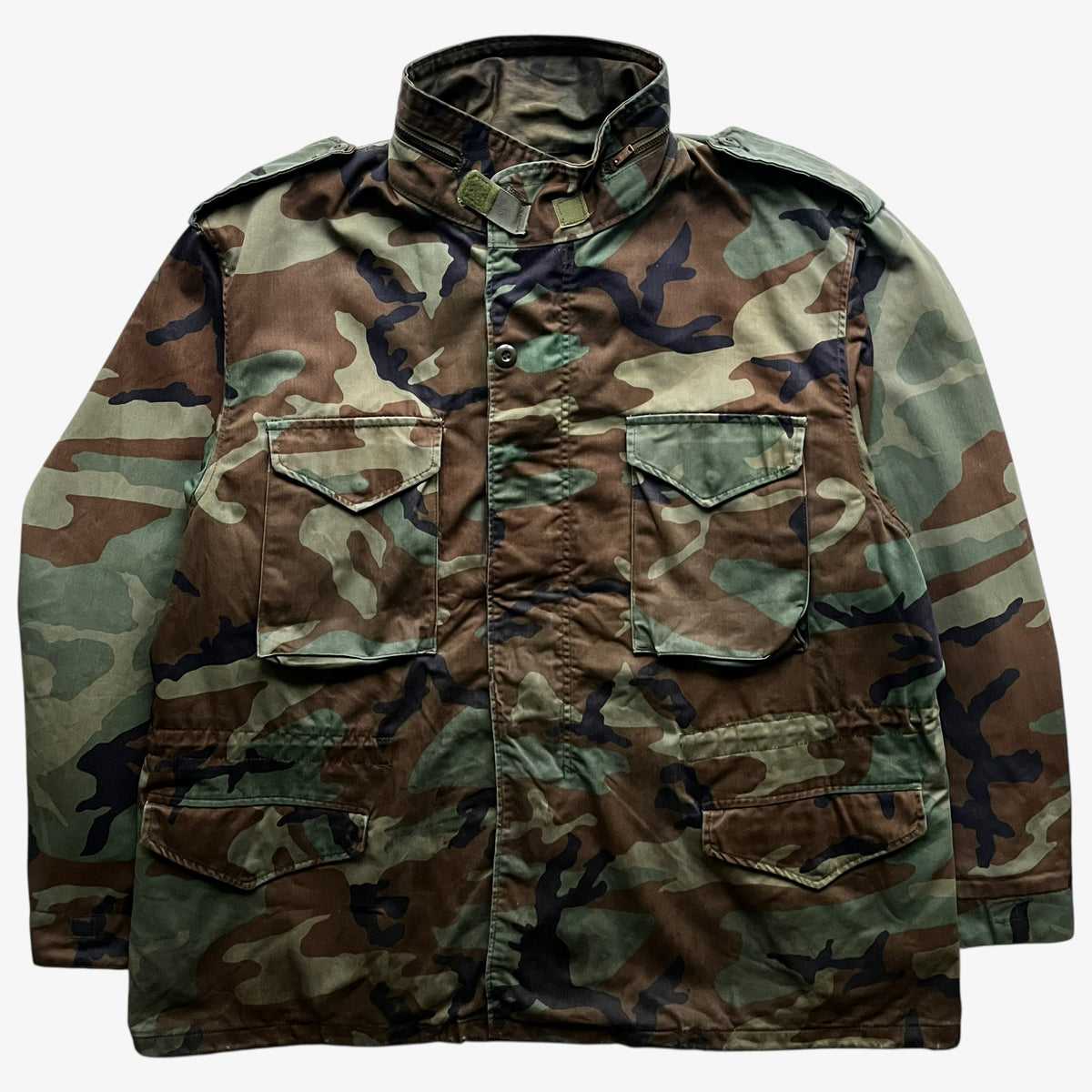 Vintage 90s men's Alpha Industries M65 cold weather green camouflage field jacket.