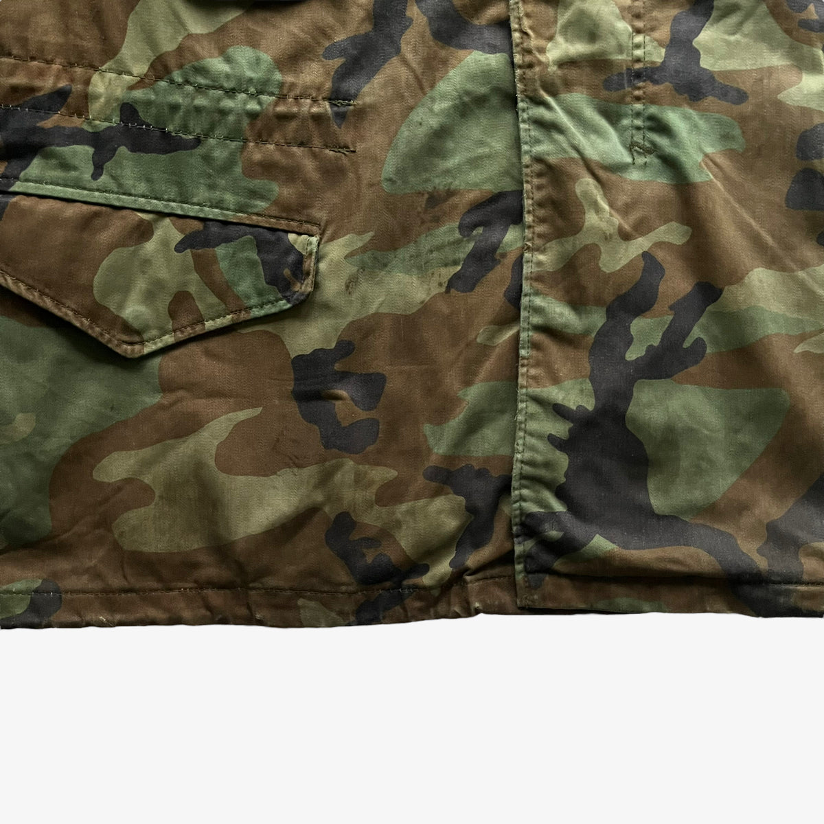 Patina on vintage 90s men's Alpha Industries M65 cold weather green camouflage field jacket.