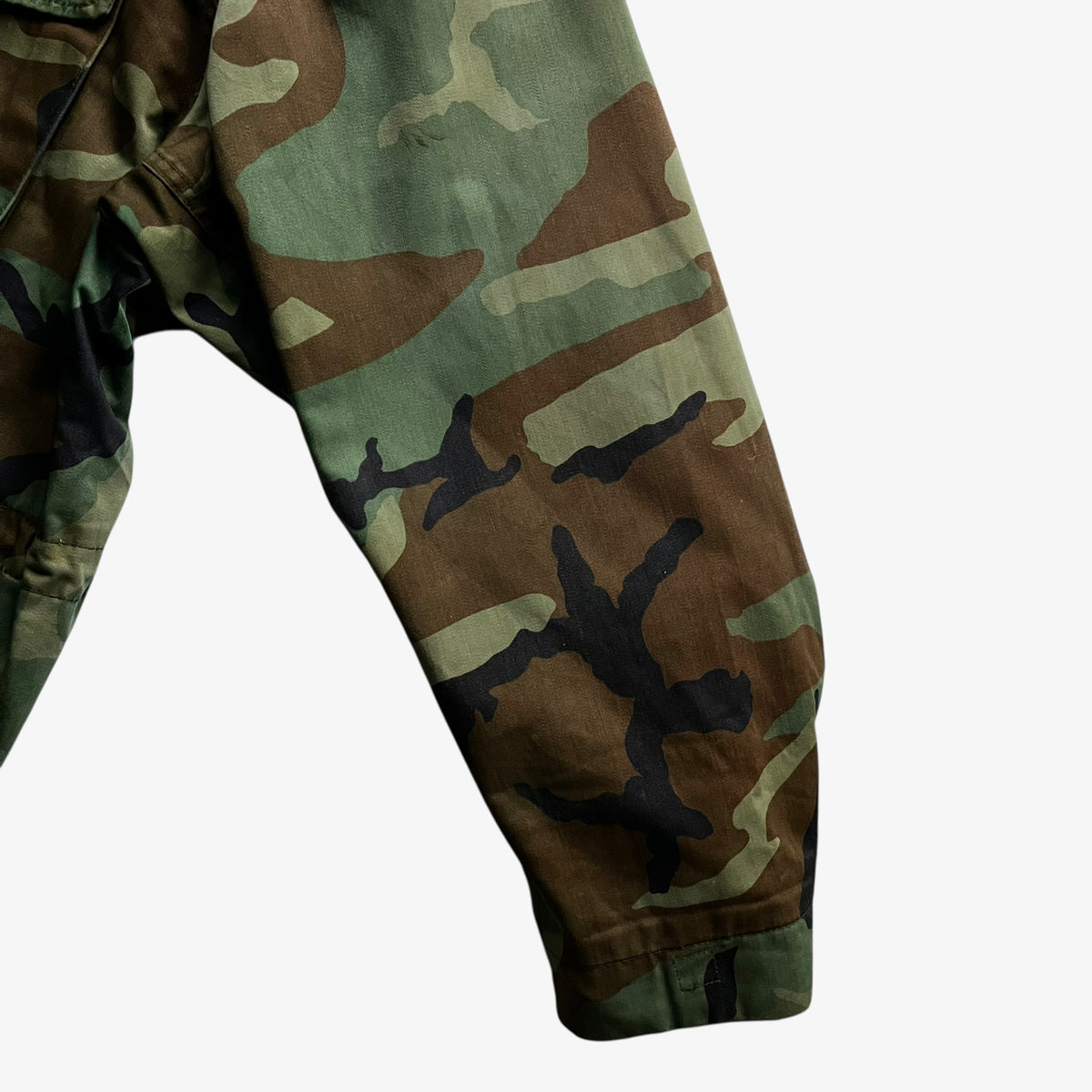 Sleeve of vintage 90s men's Alpha Industries M65 cold weather green camouflage field jacket.