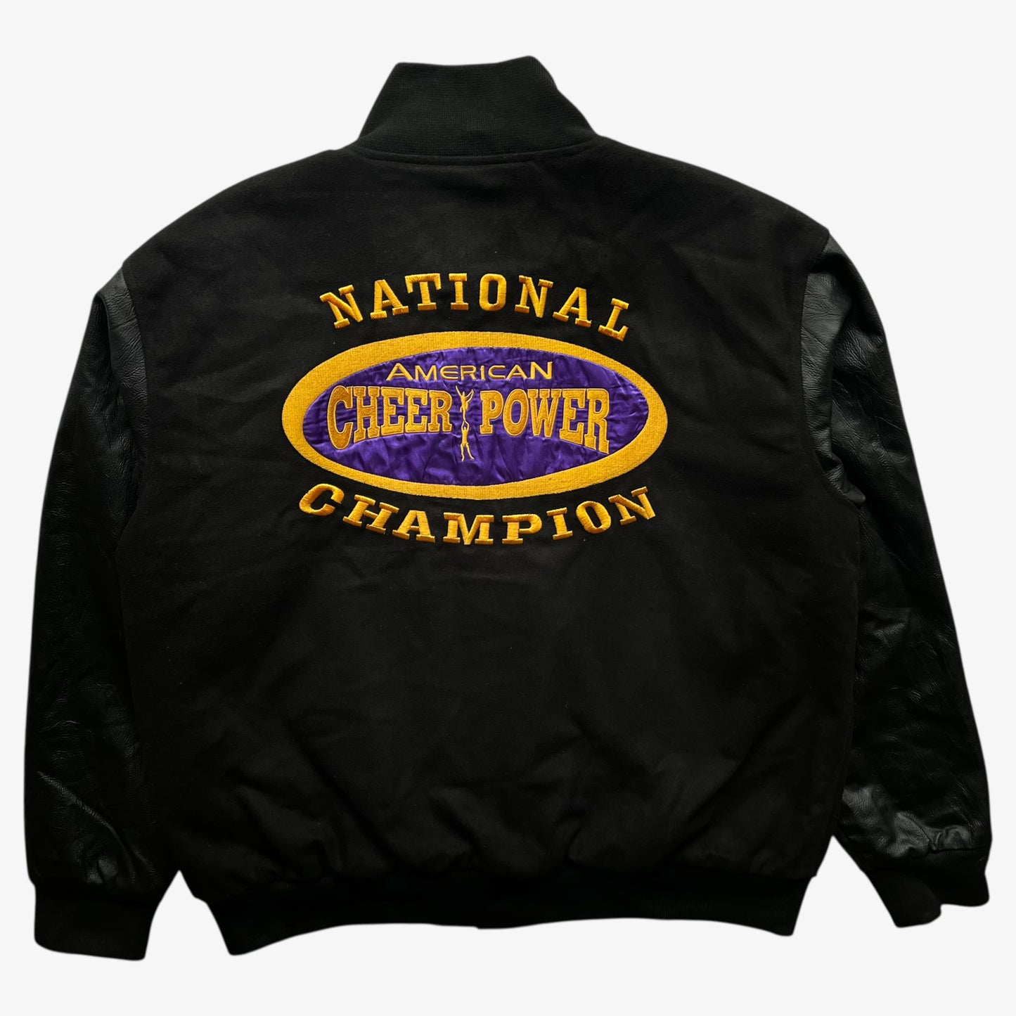 Back of vintage 90s men's American Cheer Power national champion wool blend black varsity jacket.