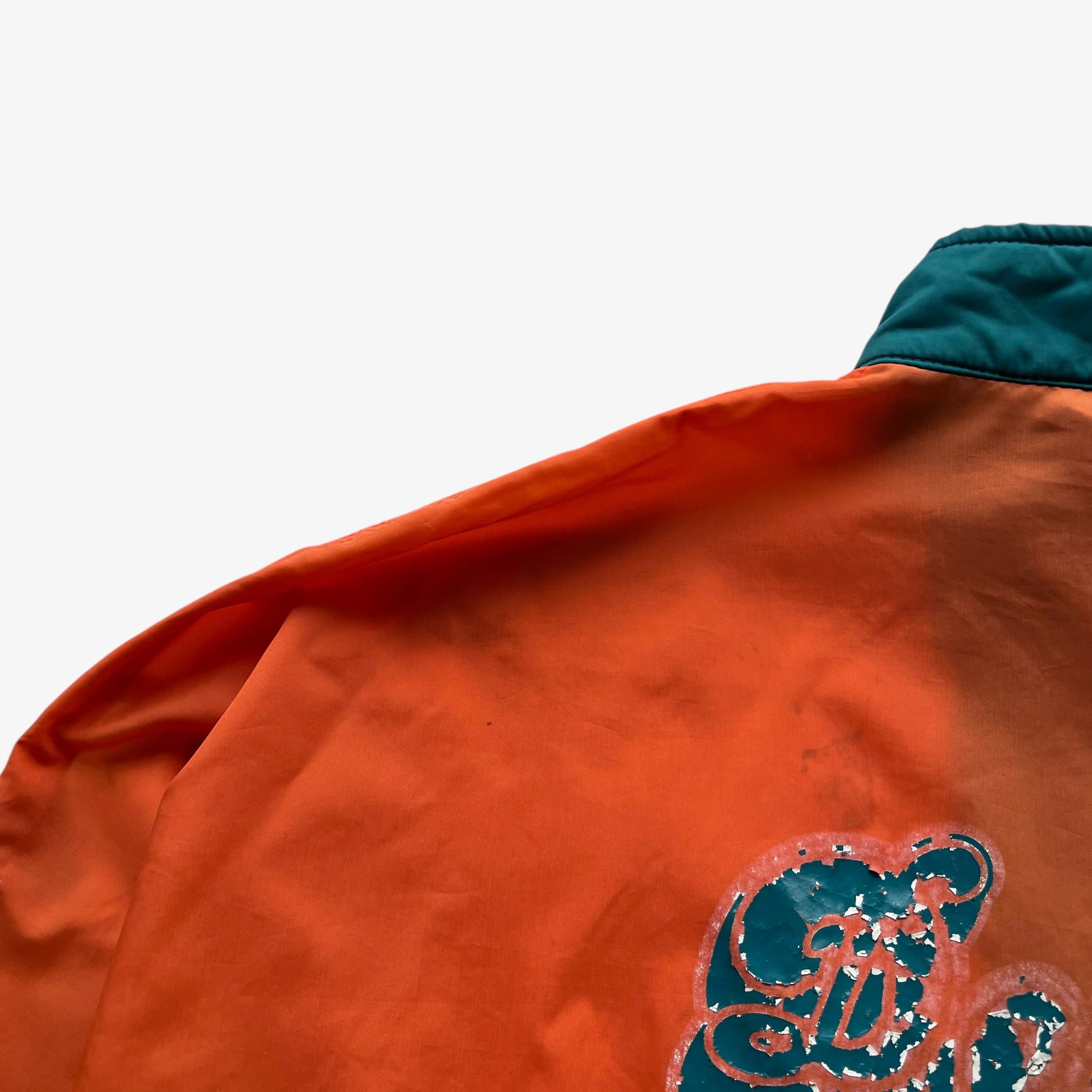 Patina on the back of men's vintage 90s Apex One NFL Miami Dolphins jacket.