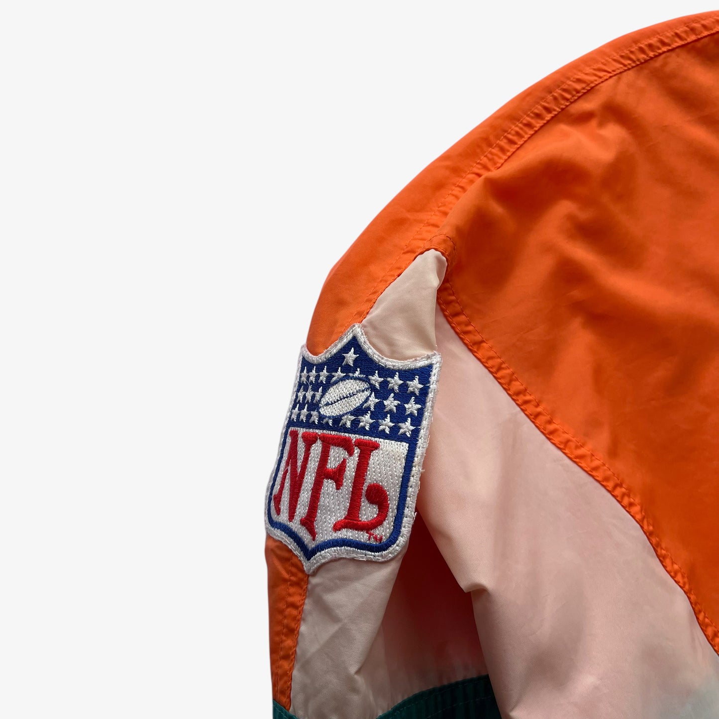 NFL embroidered bag on men's vintage 90s Apex One Miami Dolphins jacket.