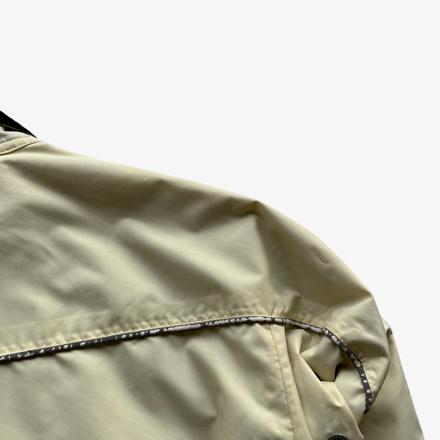 Patina on the back of vintage 90s men's Belstaff tourmaster 500 cream biker jacket.