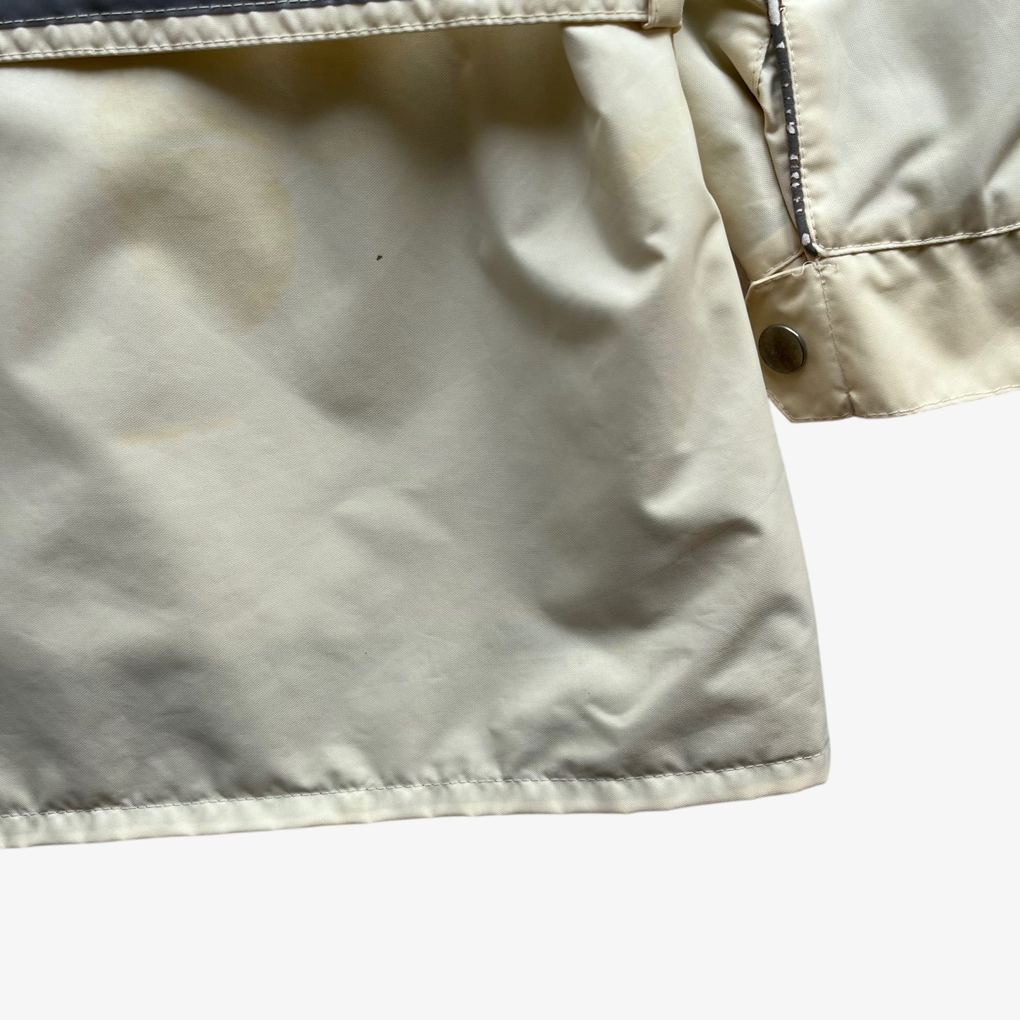 Hem of vintage 90s men's Belstaff tourmaster 500 cream biker jacket.