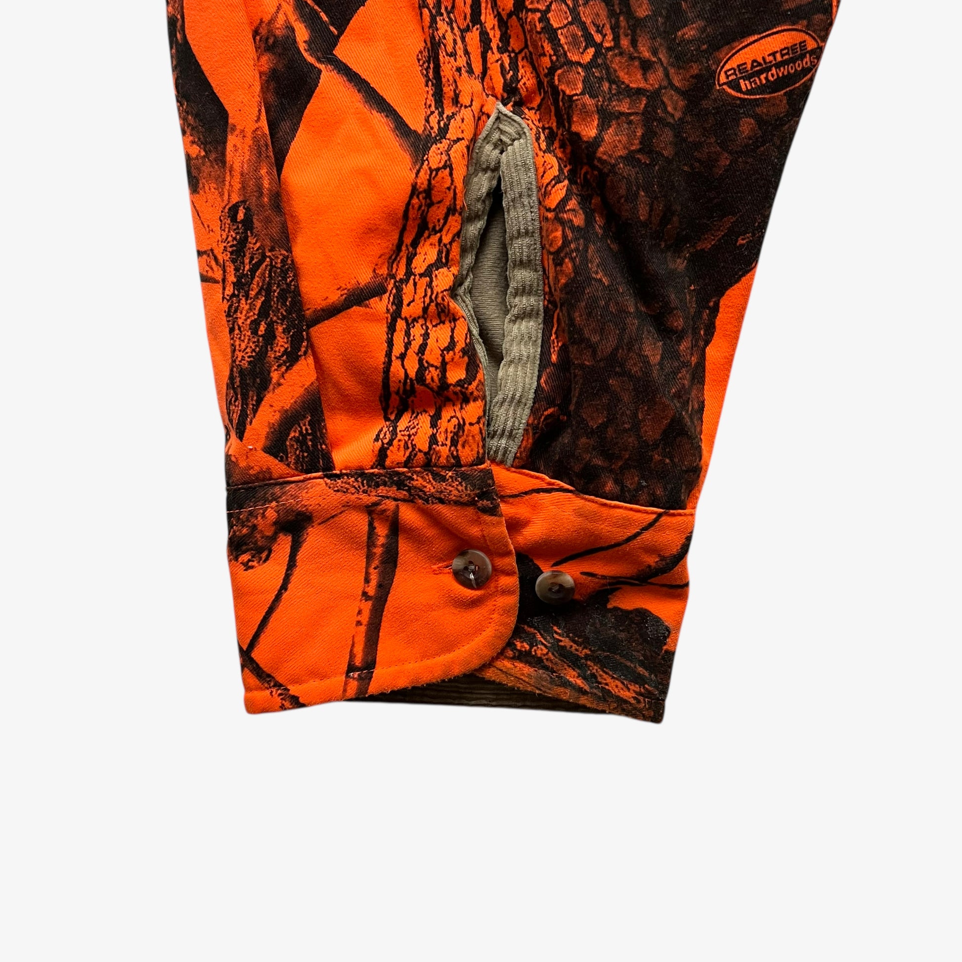 Cuff of vintage 90s men's Cabela's real tree hardwoods orange camouflage hunting jacket.