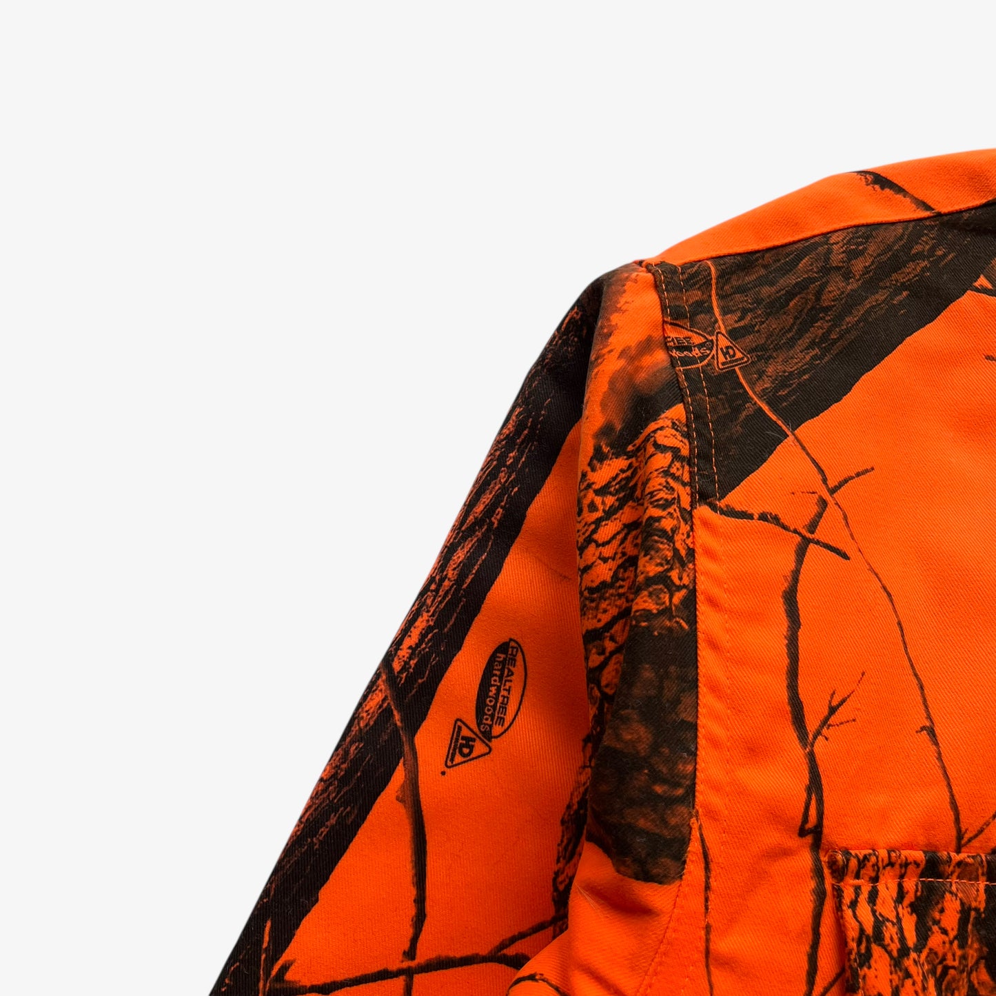 Real tree hardwoods logo on vintage 90s men's Cabela's orange camouflage hunting jacket.