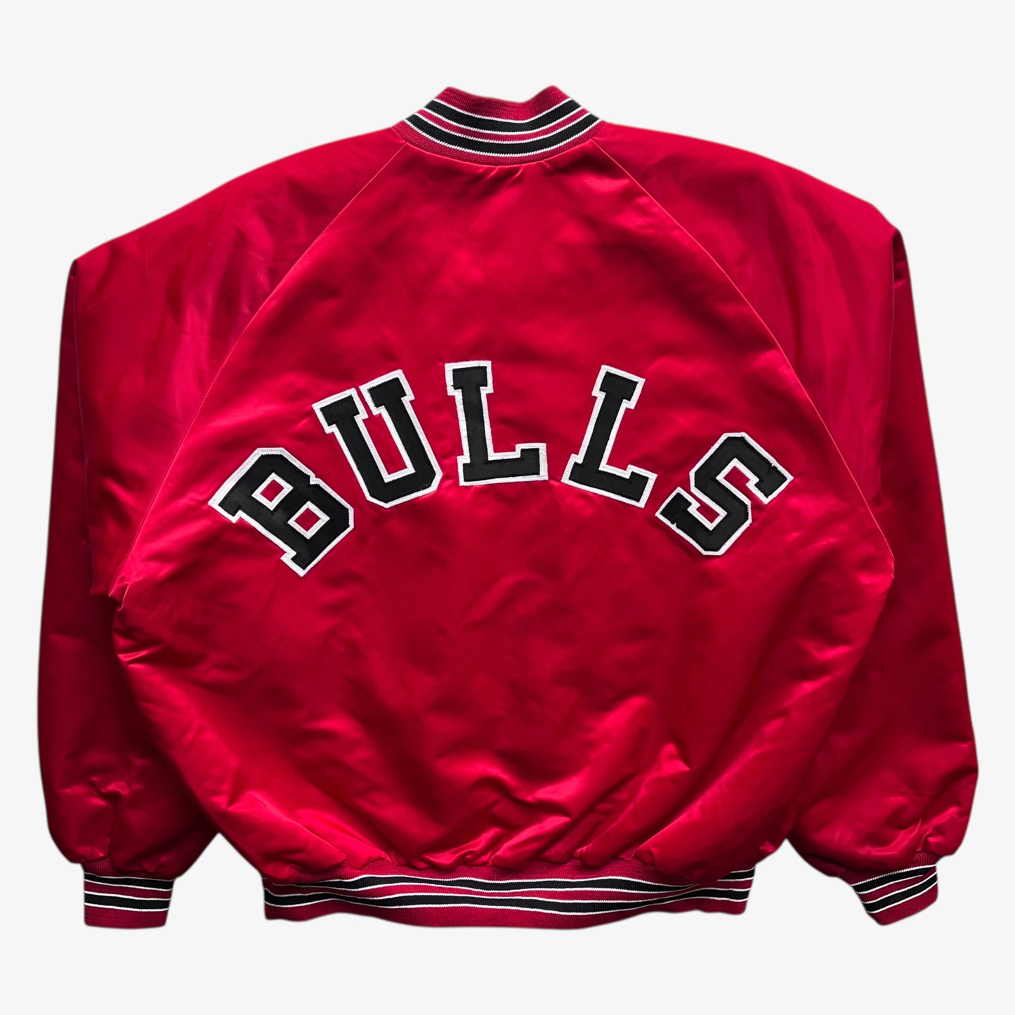 Back embroidered spell out of men's vintage 90s Chalk Line NBA Chicago Bulls red varsity jacket.