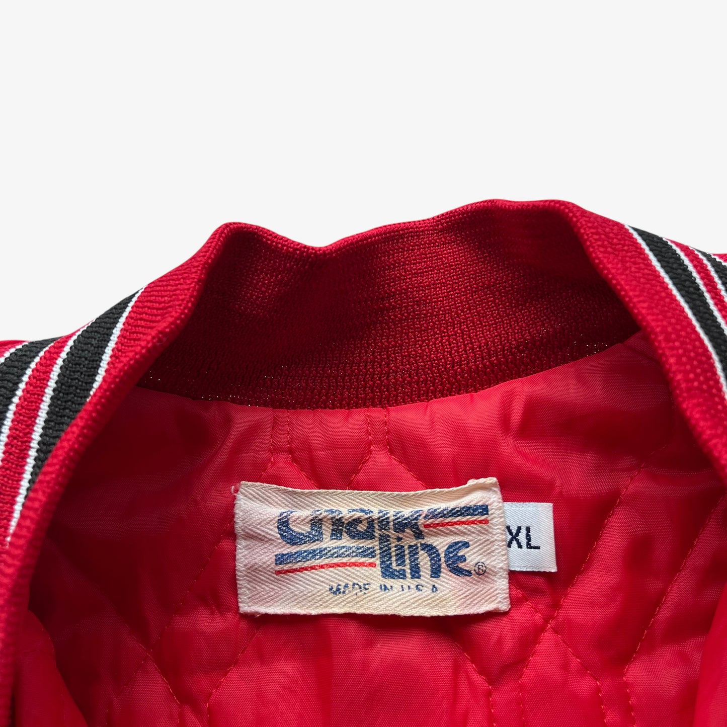 Chalk Line label stitched inside of men's vintage 90s Chalk Line NBA Chicago Bulls red varsity jacket with back embroidered spell out.