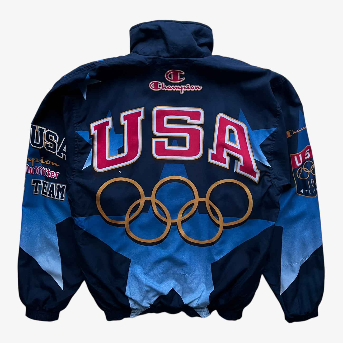Back of vintage 90s men's Champion 1996 USA Olympic team star print navy track jacket.