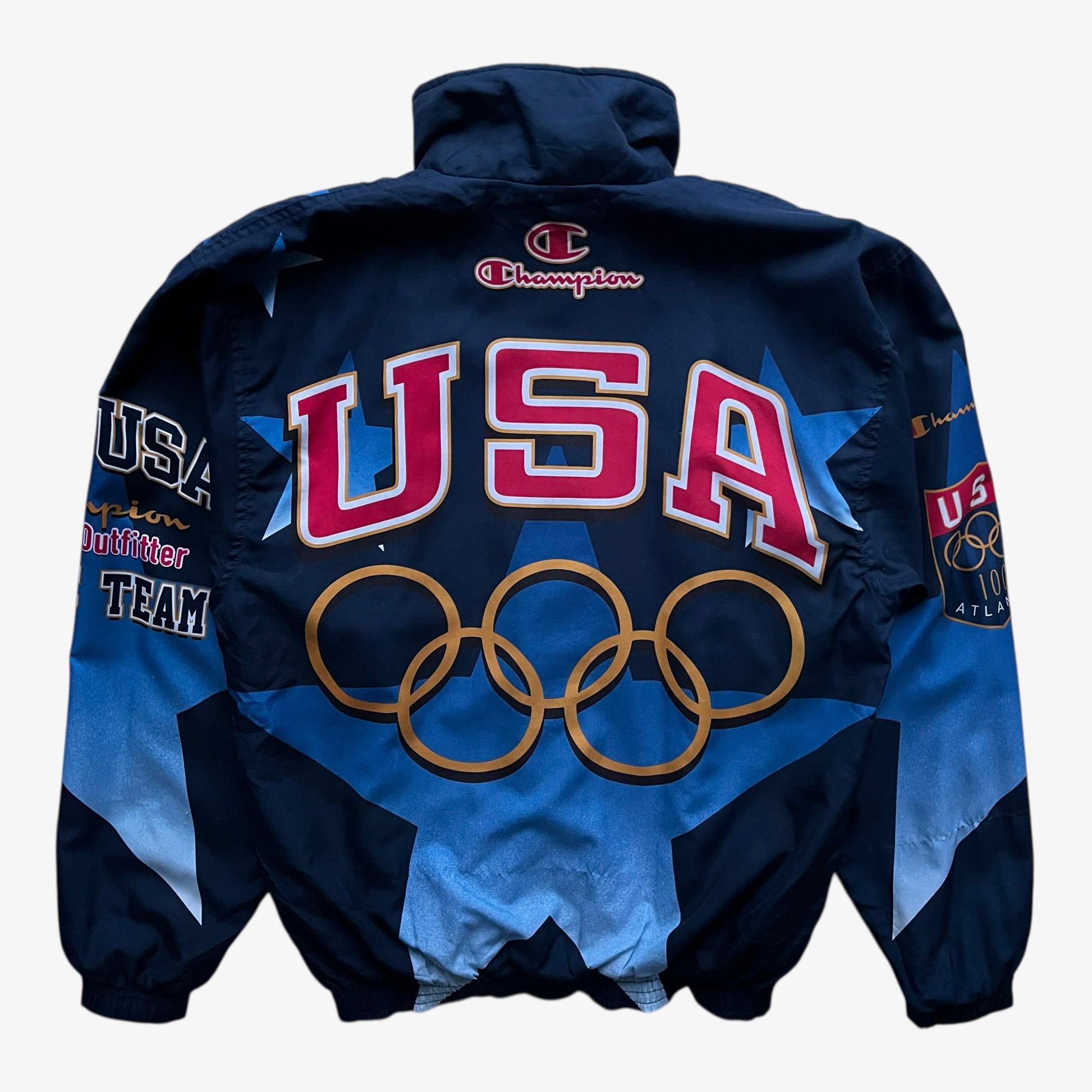 Back of vintage 90s men's Champion 1996 USA Olympic team star print navy track jacket.
