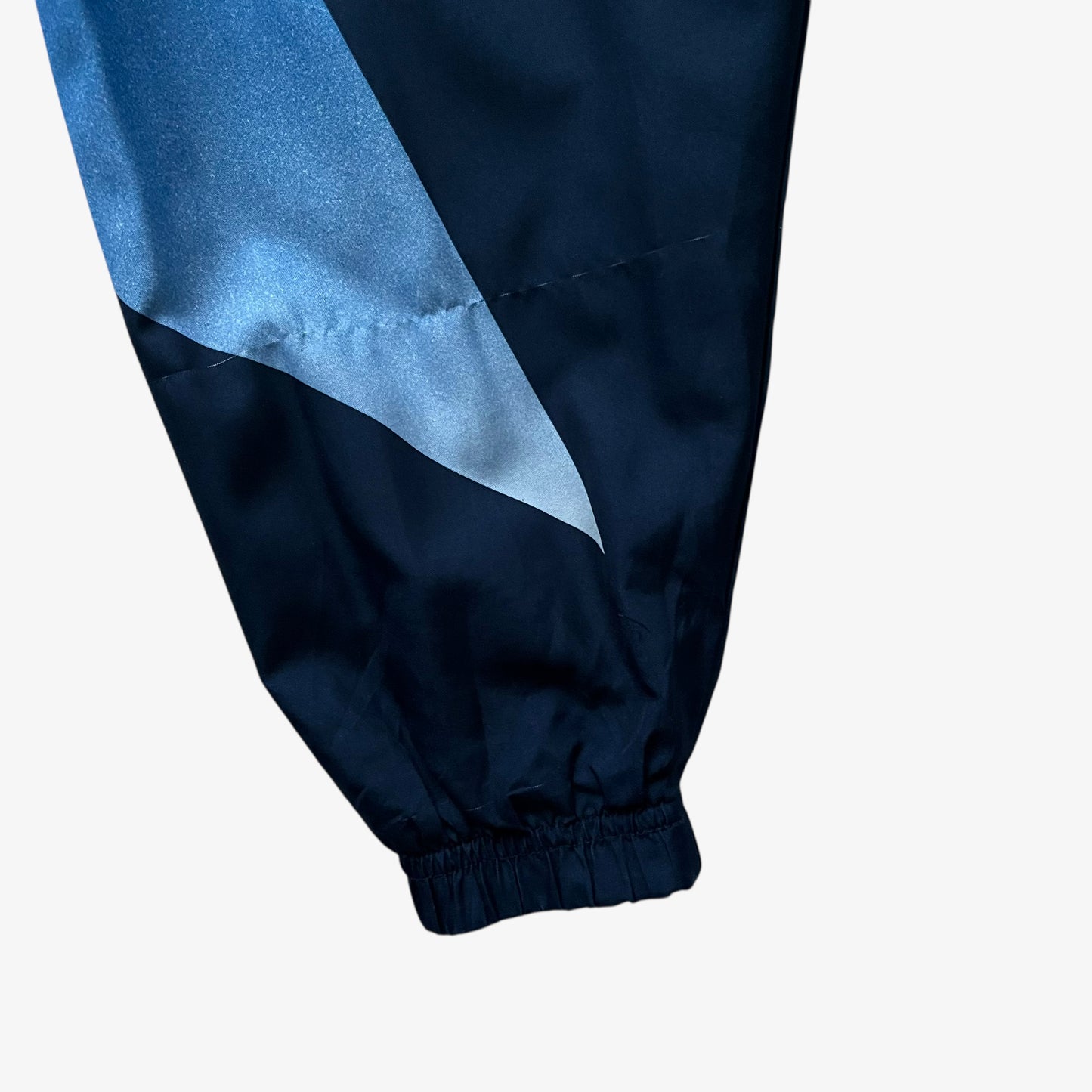 Cuff of vintage 90s men's Champion 1996 USA Olympic team star print navy track jacket.