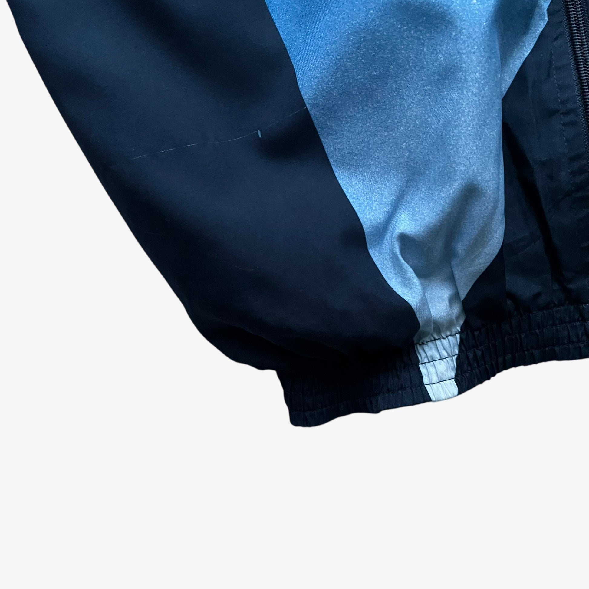 Hem of vintage 90s men's Champion 1996 USA Olympic team star print navy track jacket.