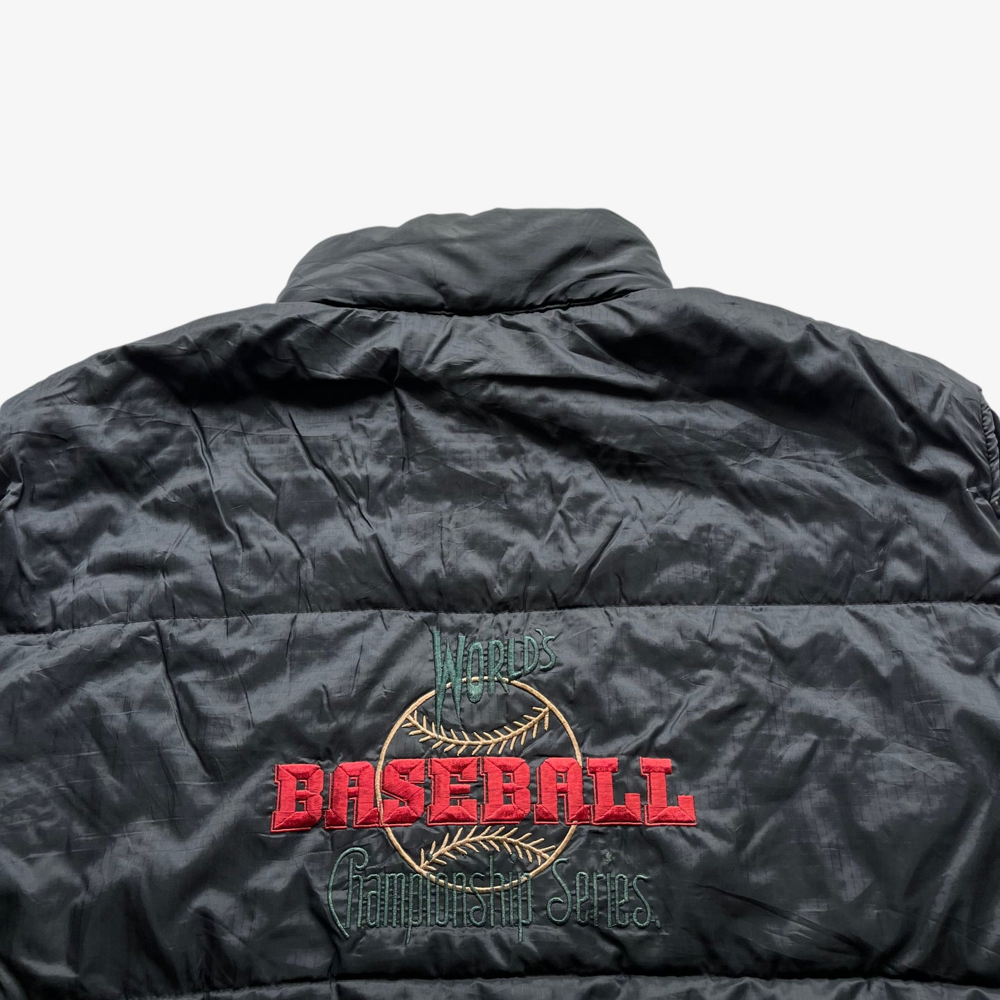 World baseball championship series spell out on the back of vintage 90s men's Efro black gilet.