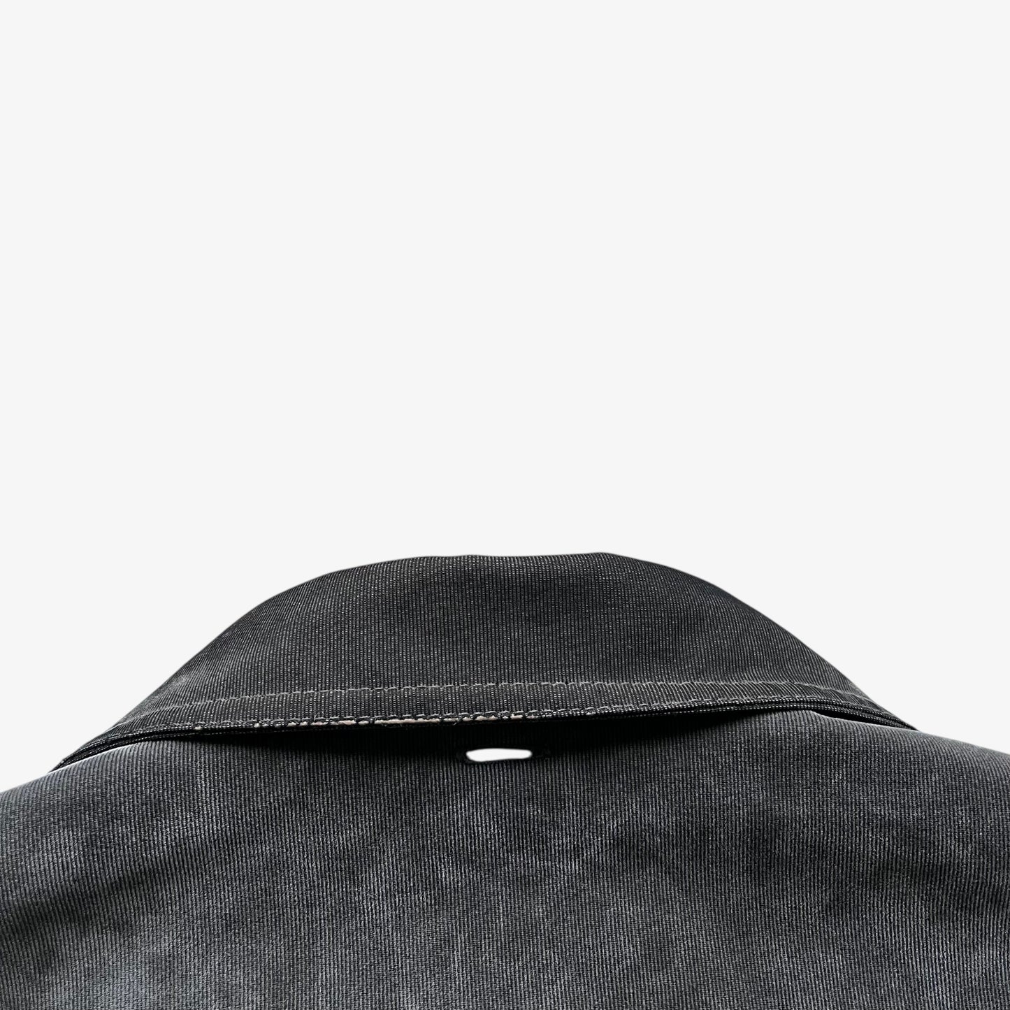 Collar of a vintage 90s men's Gianfranco Ferre Jeans khaki ribbed jacket.
