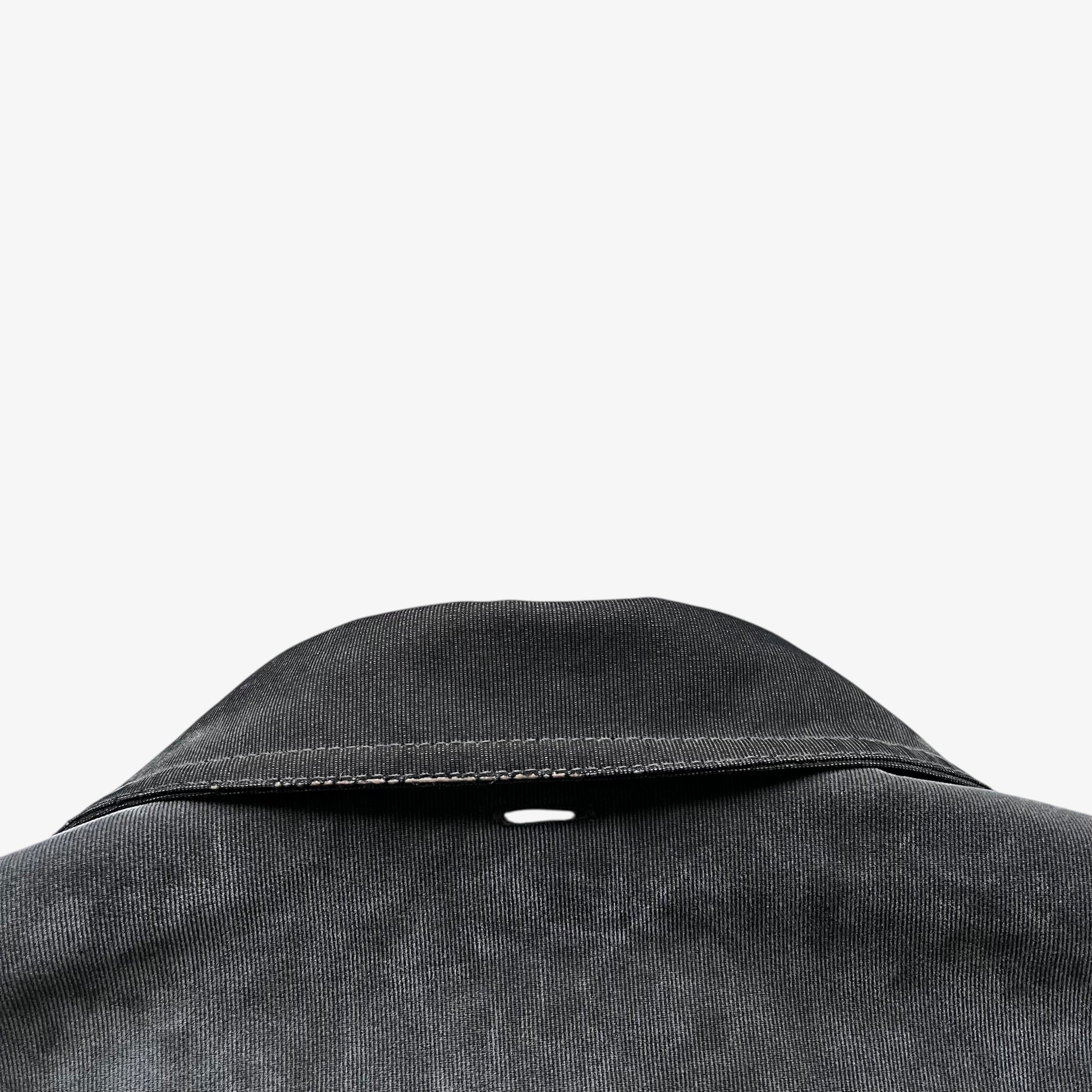 Collar of a vintage 90s men's Gianfranco Ferre Jeans khaki ribbed jacket.