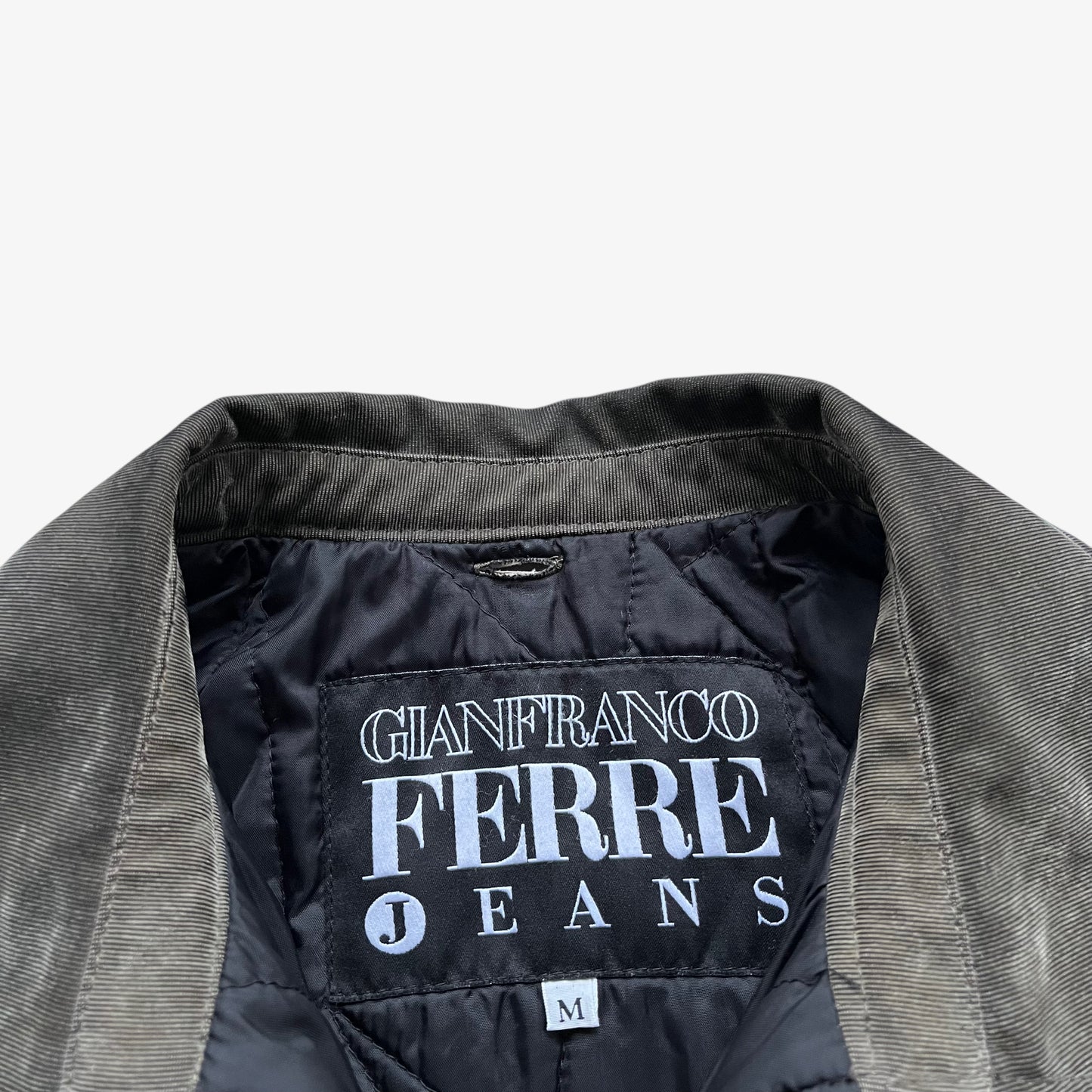 Gianfranco Ferre Jeans label stitched inside of a vintage 90s men's khaki ribbed jacket.