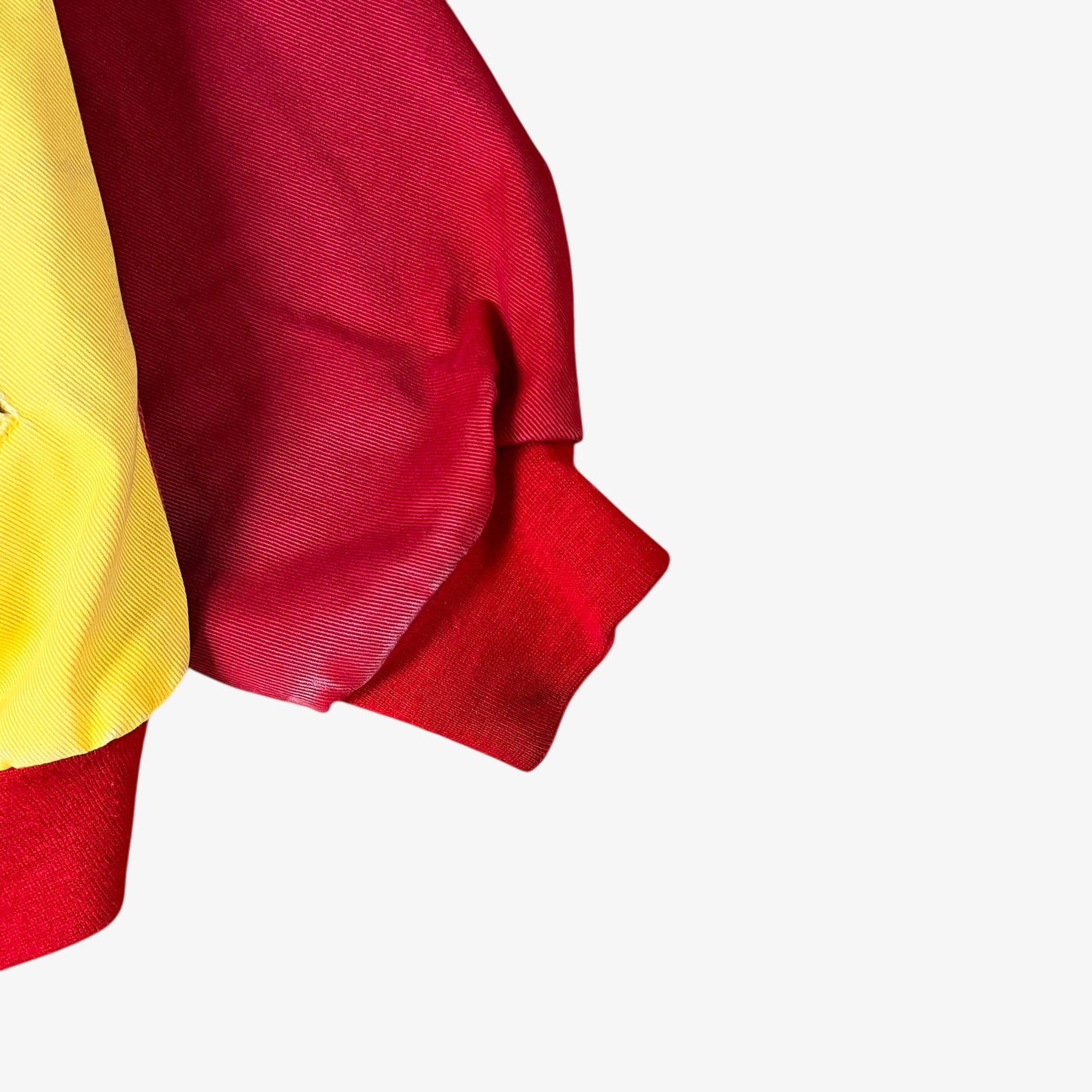 Fading on sleeve of vintage 90s Jeff Hamilton JH Design Ernie Irvan 36 M&M yellow NASCAR jacket.