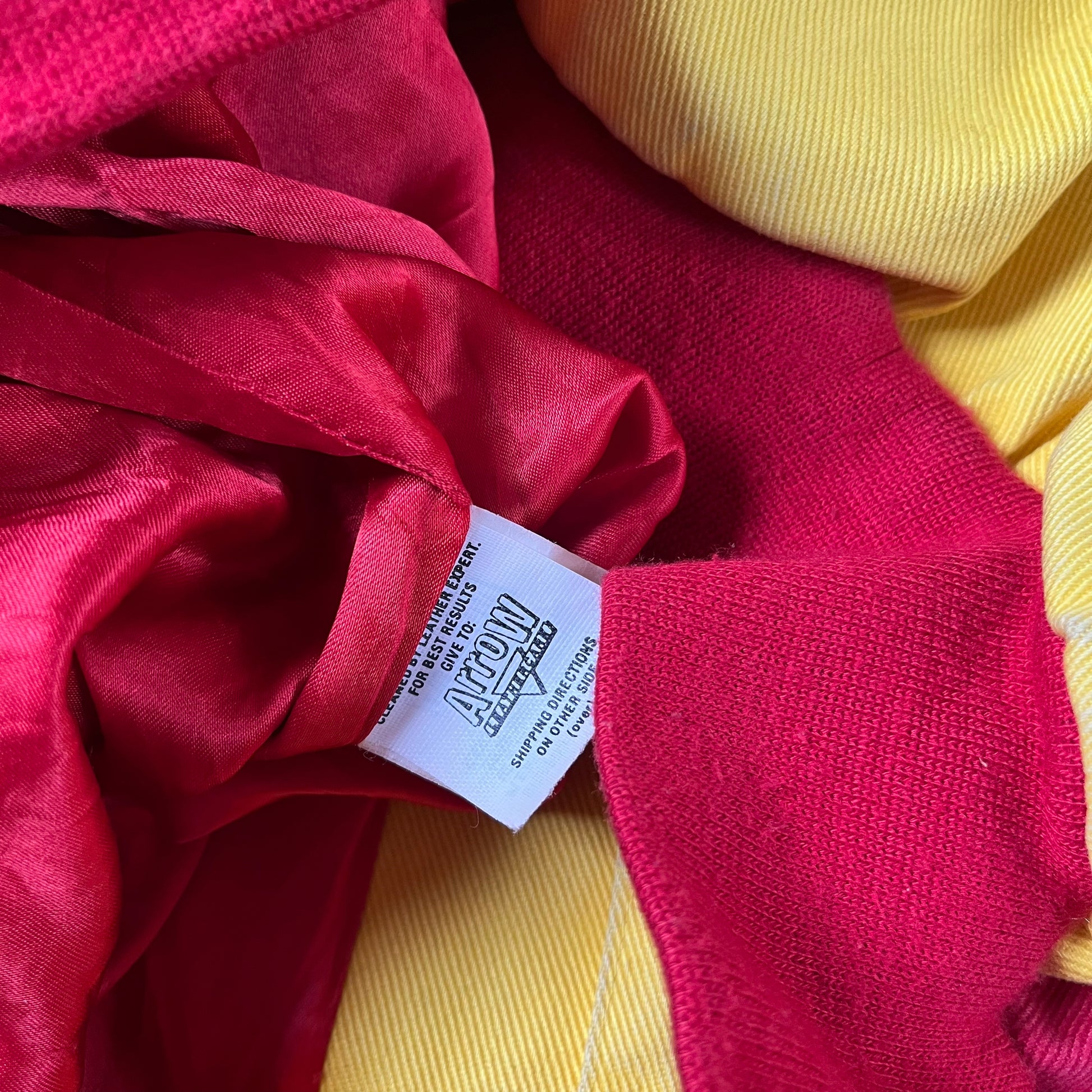 Inside arrow label of vintage 90s Jeff Hamilton JH Design Ernie Irvan 36 M&M yellow NASCAR jacket.