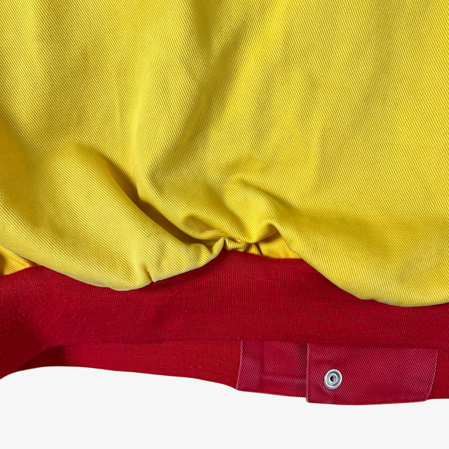 Back hem of vintage 90s Jeff Hamilton JH Design Ernie Irvan 36 M&M yellow NASCAR jacket.