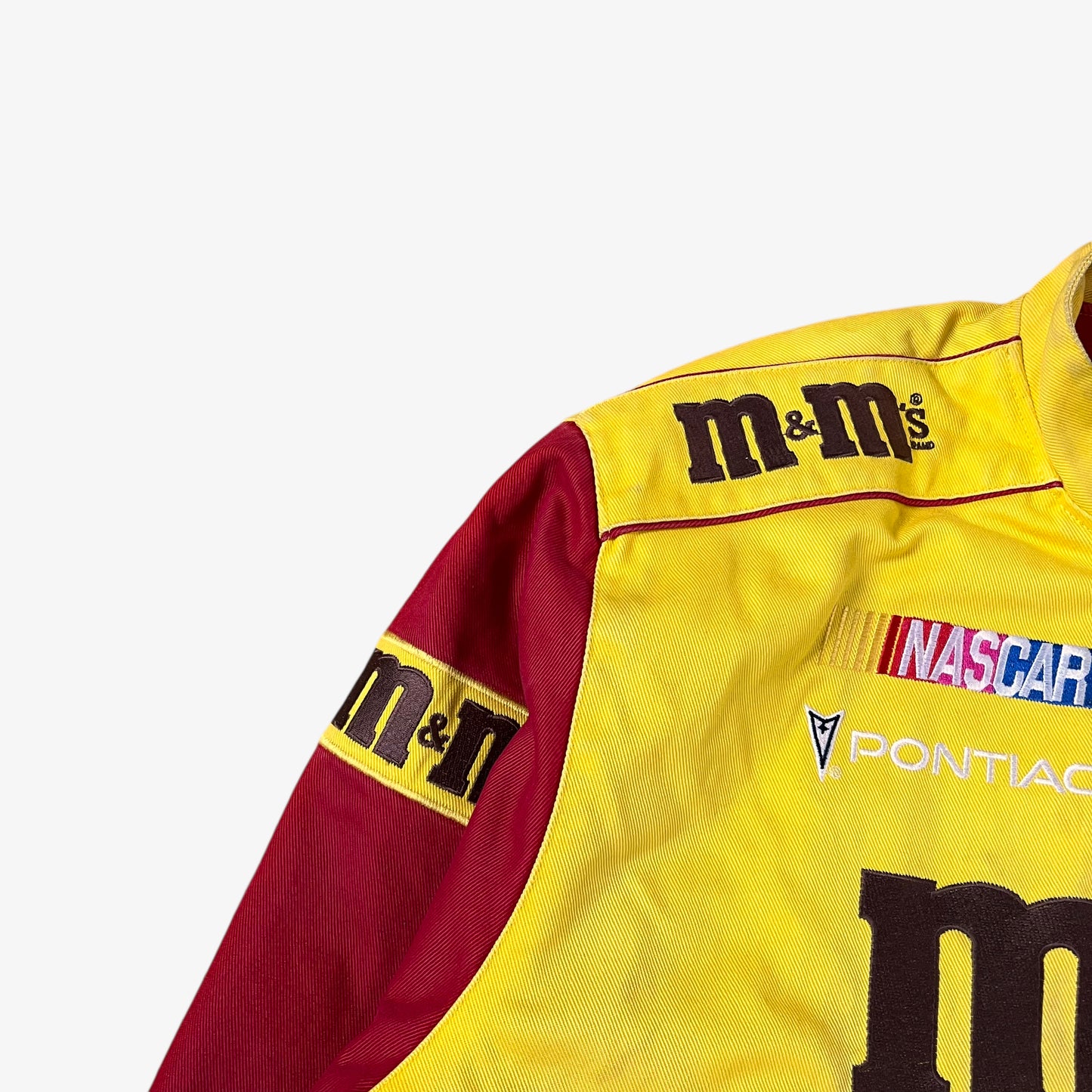 Sleeve of vintage 90s Jeff Hamilton JH Design Ernie Irvan 36 M&M yellow NASCAR jacket.