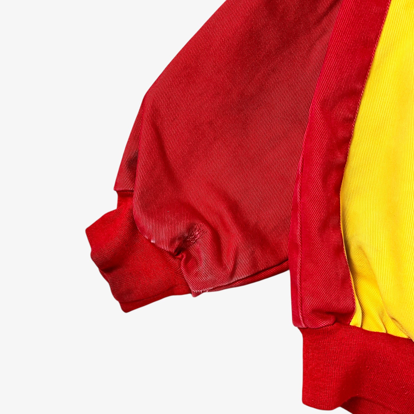 Wear on sleeve of vintage 90s Jeff Hamilton JH Design Ernie Irvan 36 M&M yellow NASCAR jacket.