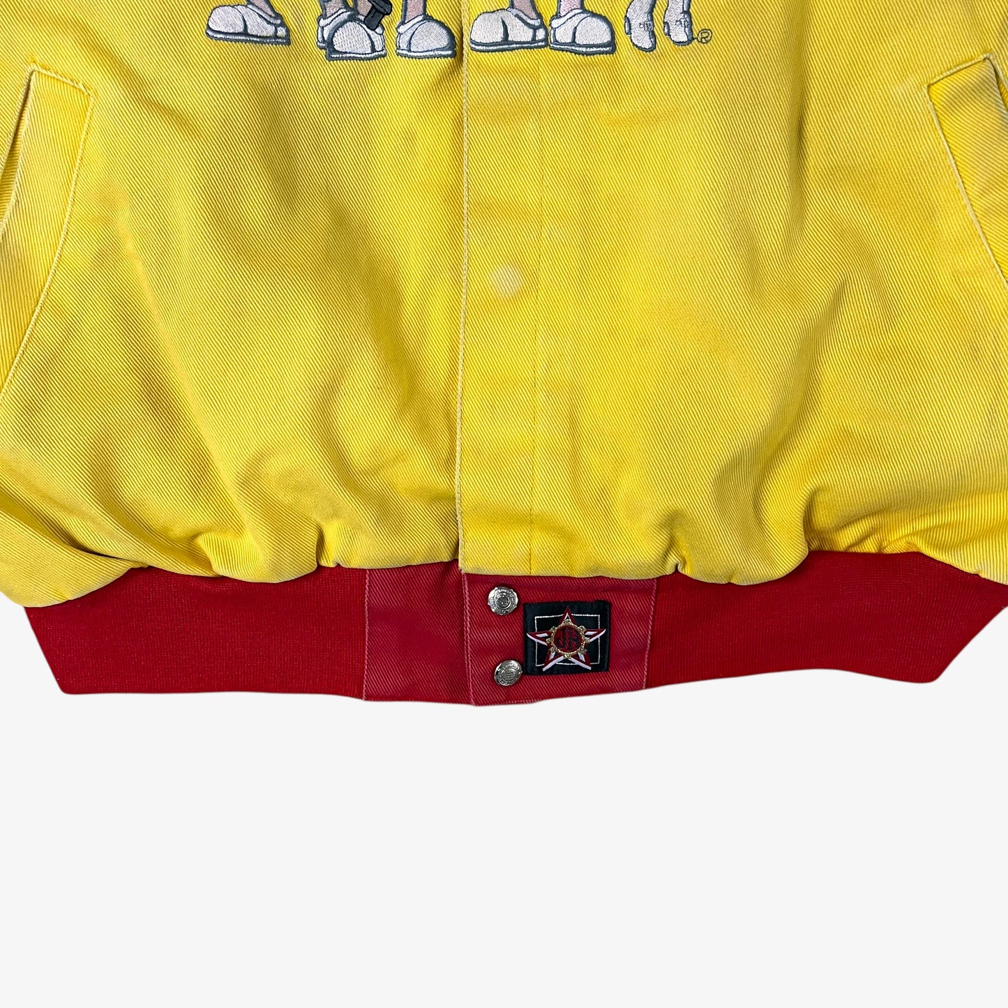 Hem label of vintage 90s Jeff Hamilton JH Design Ernie Irvan 36 M&M yellow NASCAR jacket.