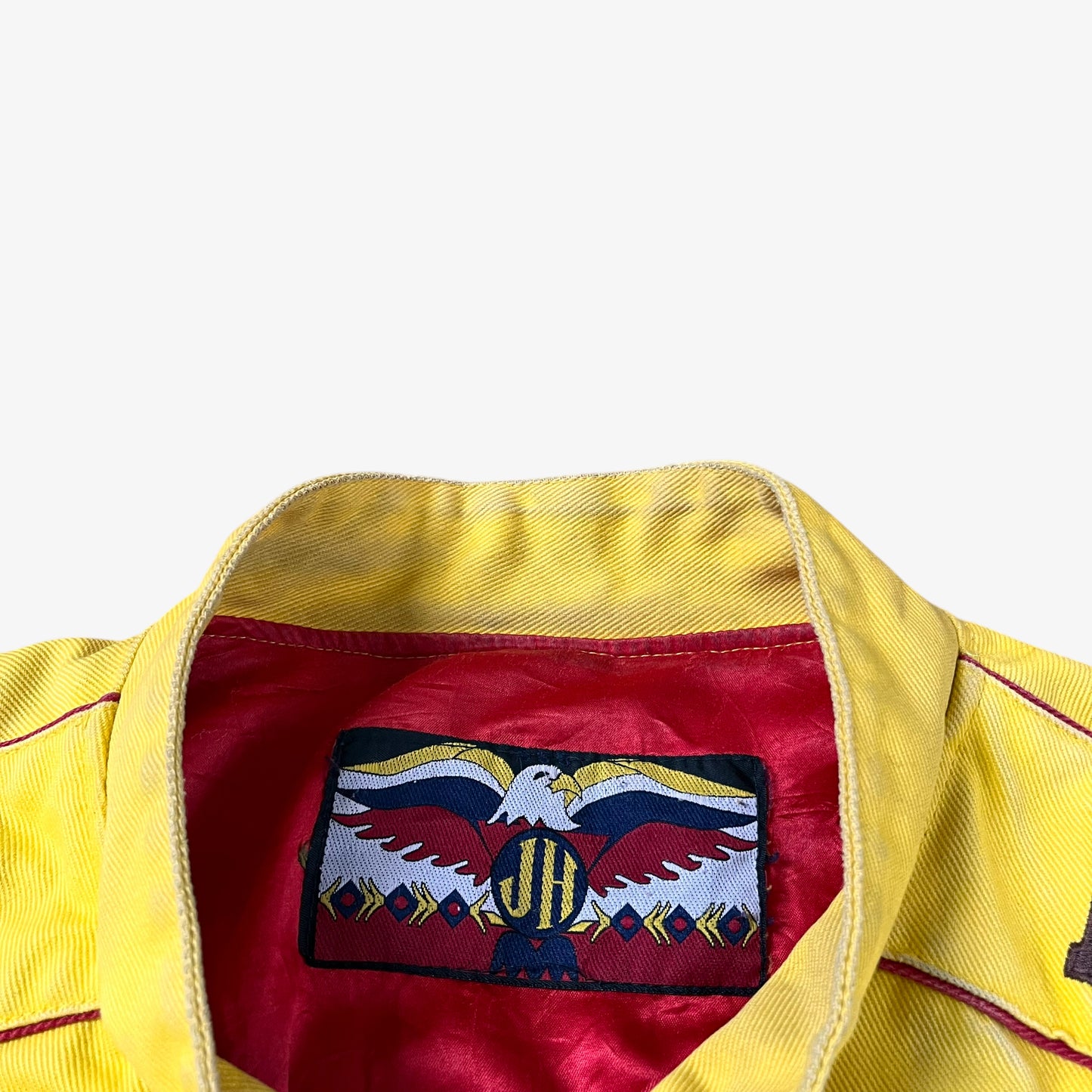 Label of vintage 90s Jeff Hamilton JH Design Ernie Irvan 36 M&M yellow NASCAR jacket.