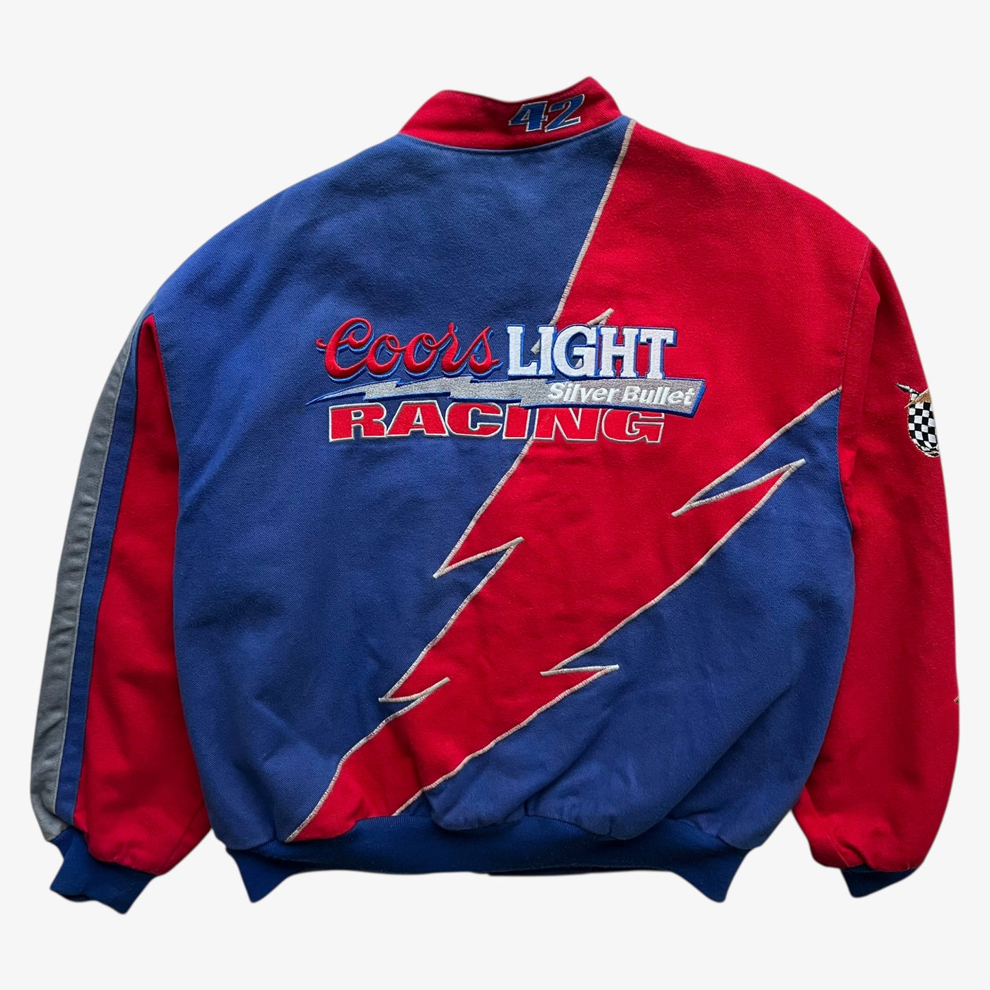 Back of a vintage 90s men's Jeff Hamilton Coors Light silver bullet nascar jacket featuring an embroidered lightning bolt.