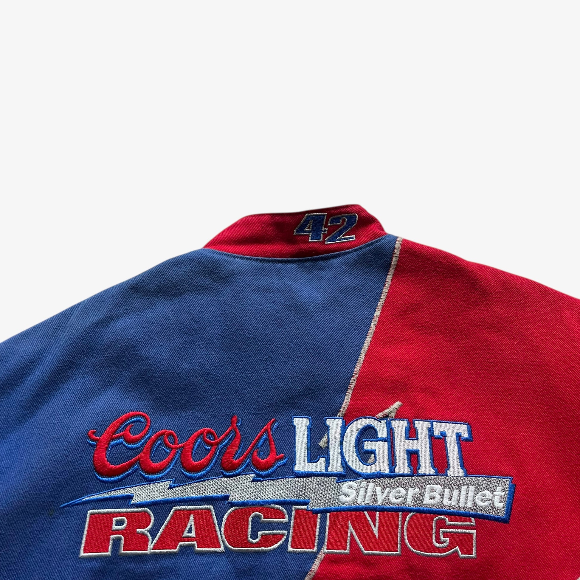 Close up of the back embroidery on a vintage 90s men's Jeff Hamilton Coors Light silver bullet nascar jacket.