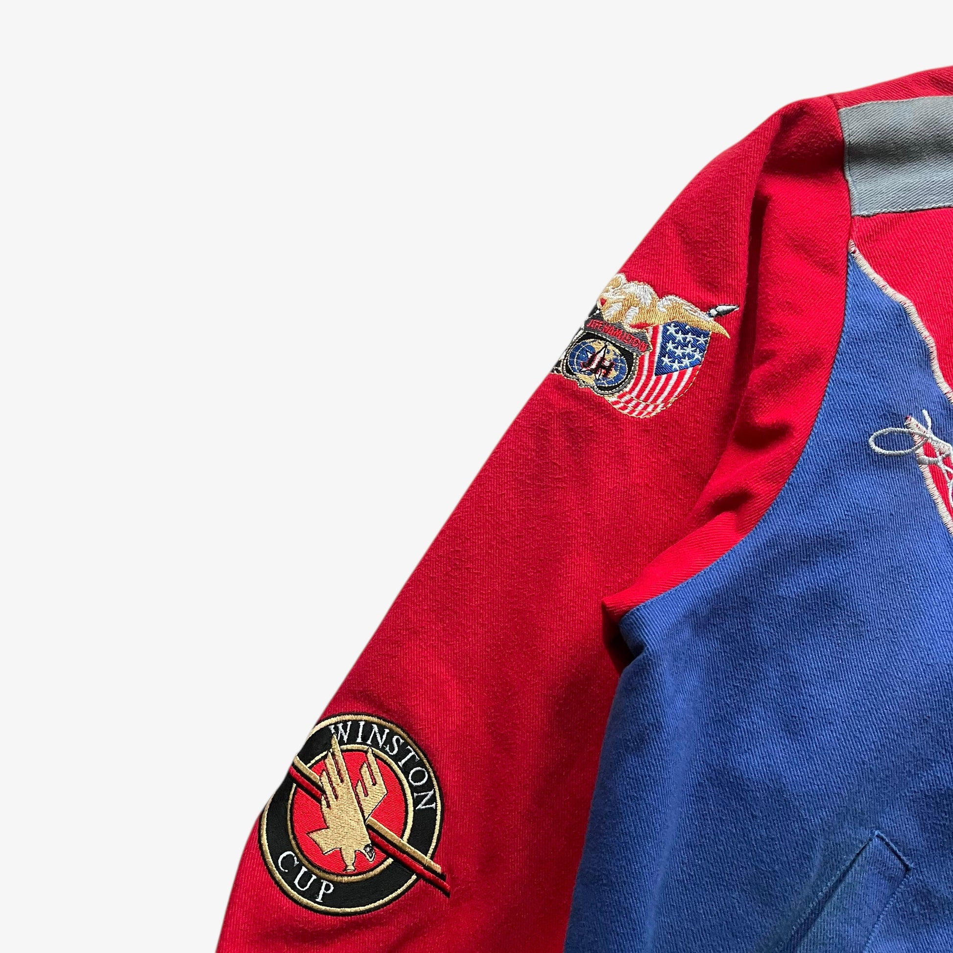 Embroidered badges on the sleeve of a vintage 90s men's Jeff Hamilton Coors Light silver bullet nascar jacket.