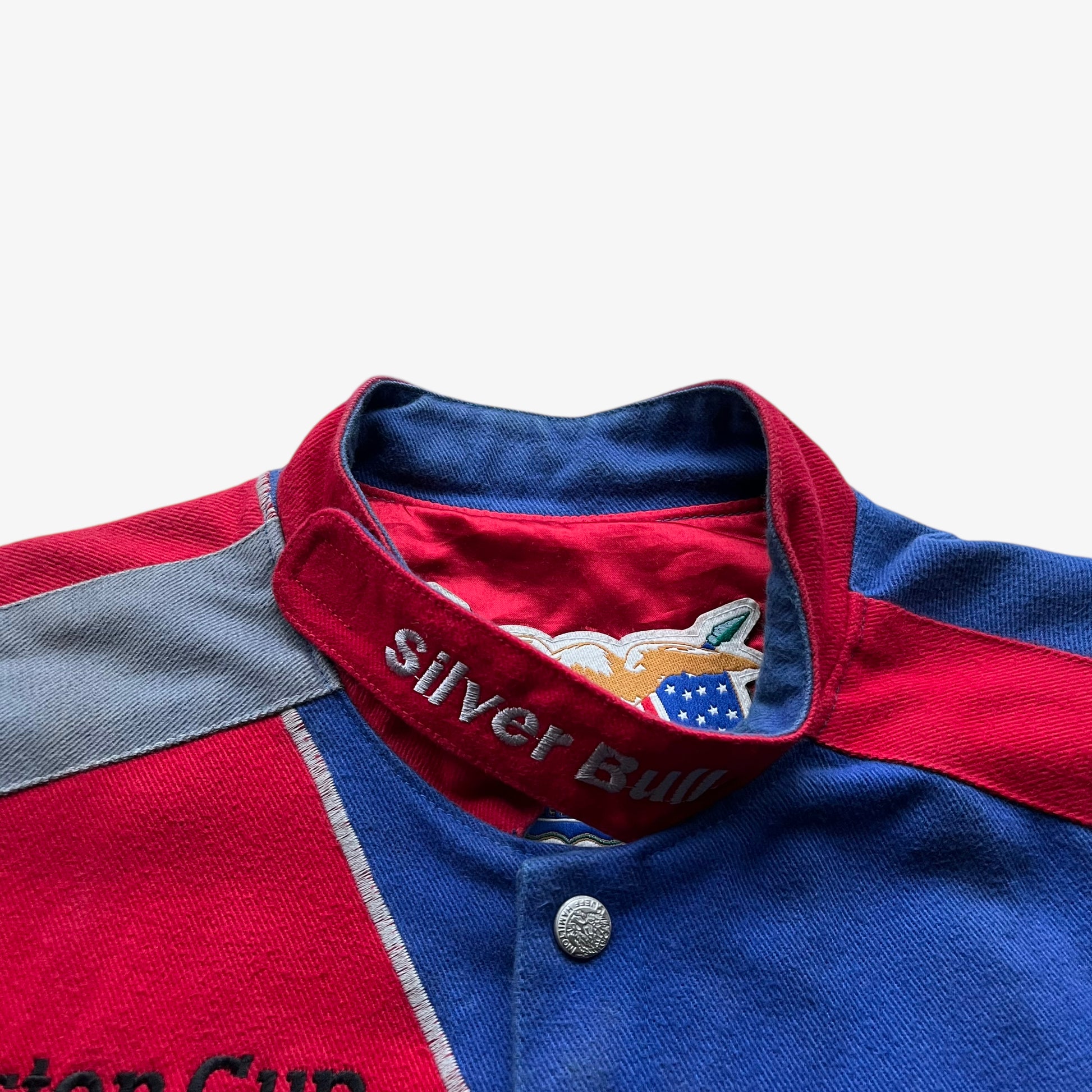 Silver bullet embroidered collar on a vintage 90s men's Jeff Hamilton Coors Light nascar jacket.