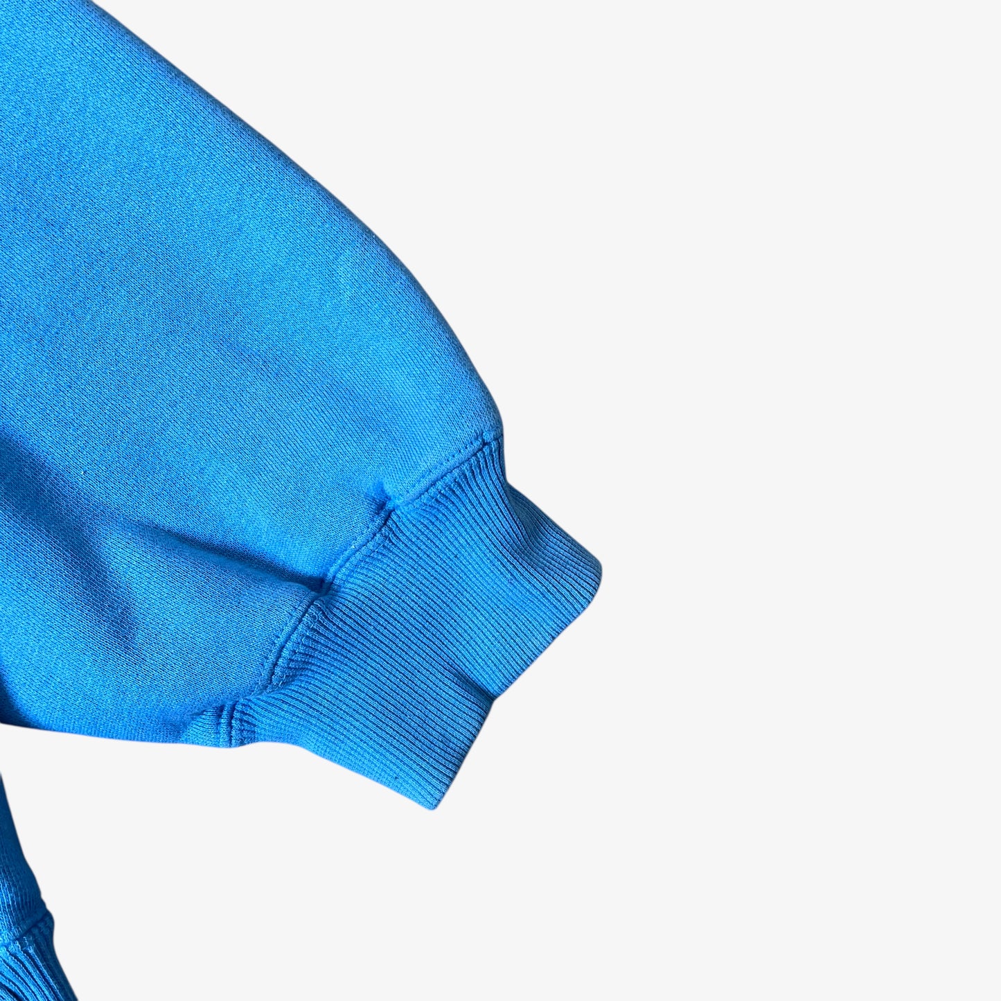 Sleeve of vintage 90s men's Johnny Blaze blue hoodie.