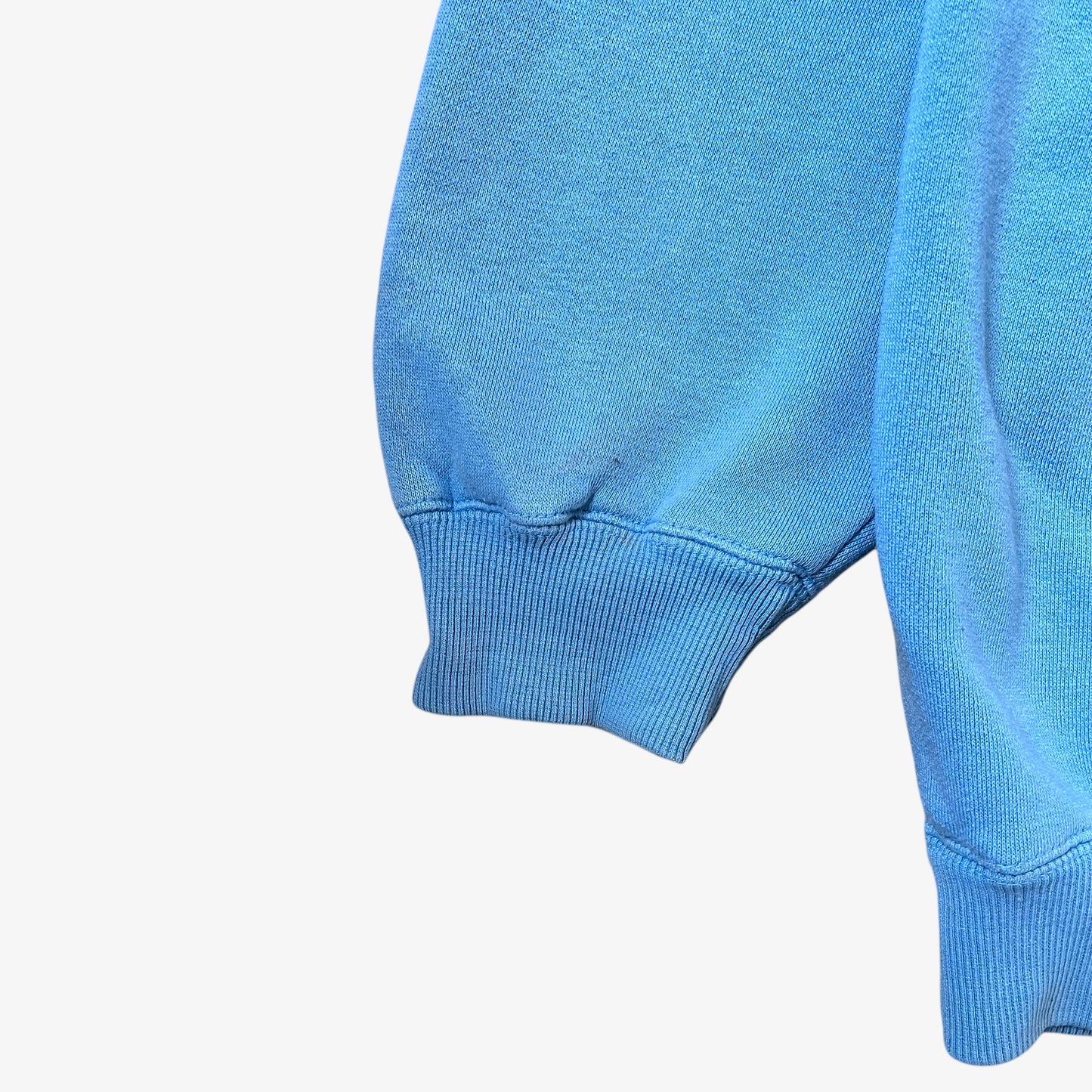 Ribbed cuff of a vintage 90s men's Johnny Blaze blue hoodie.