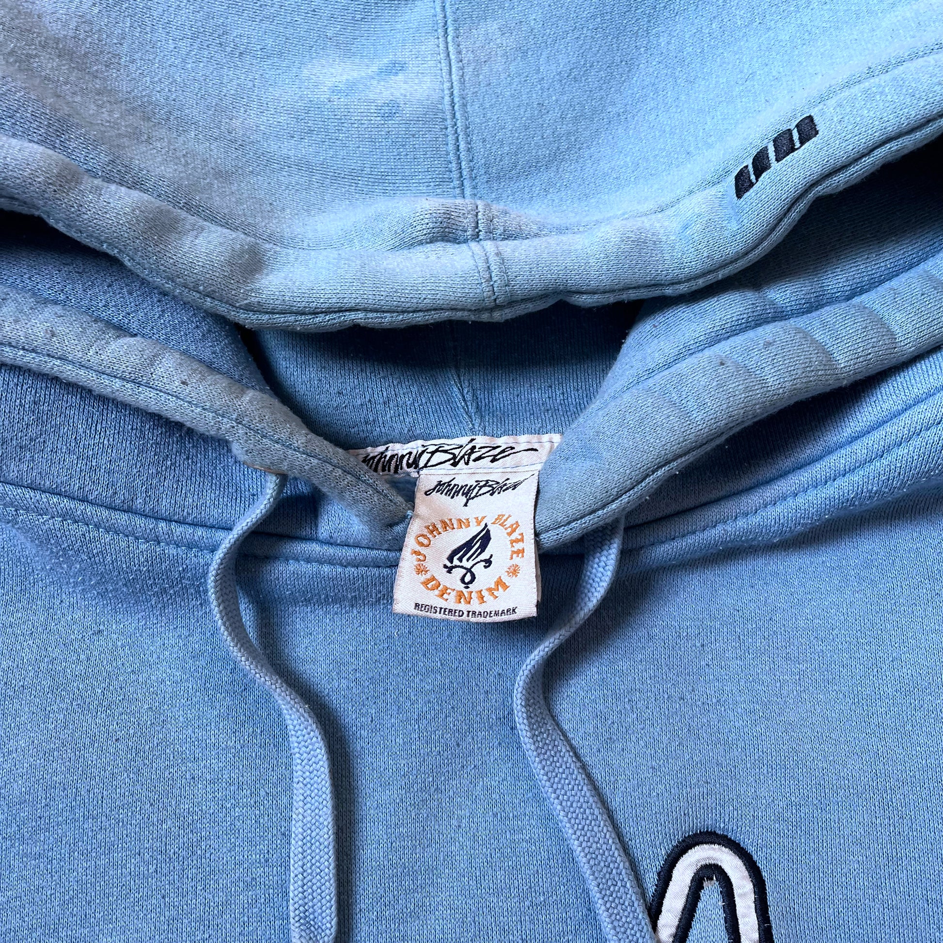 Johnny Blaze label inside of a vintage 90s men's blue hoodie.