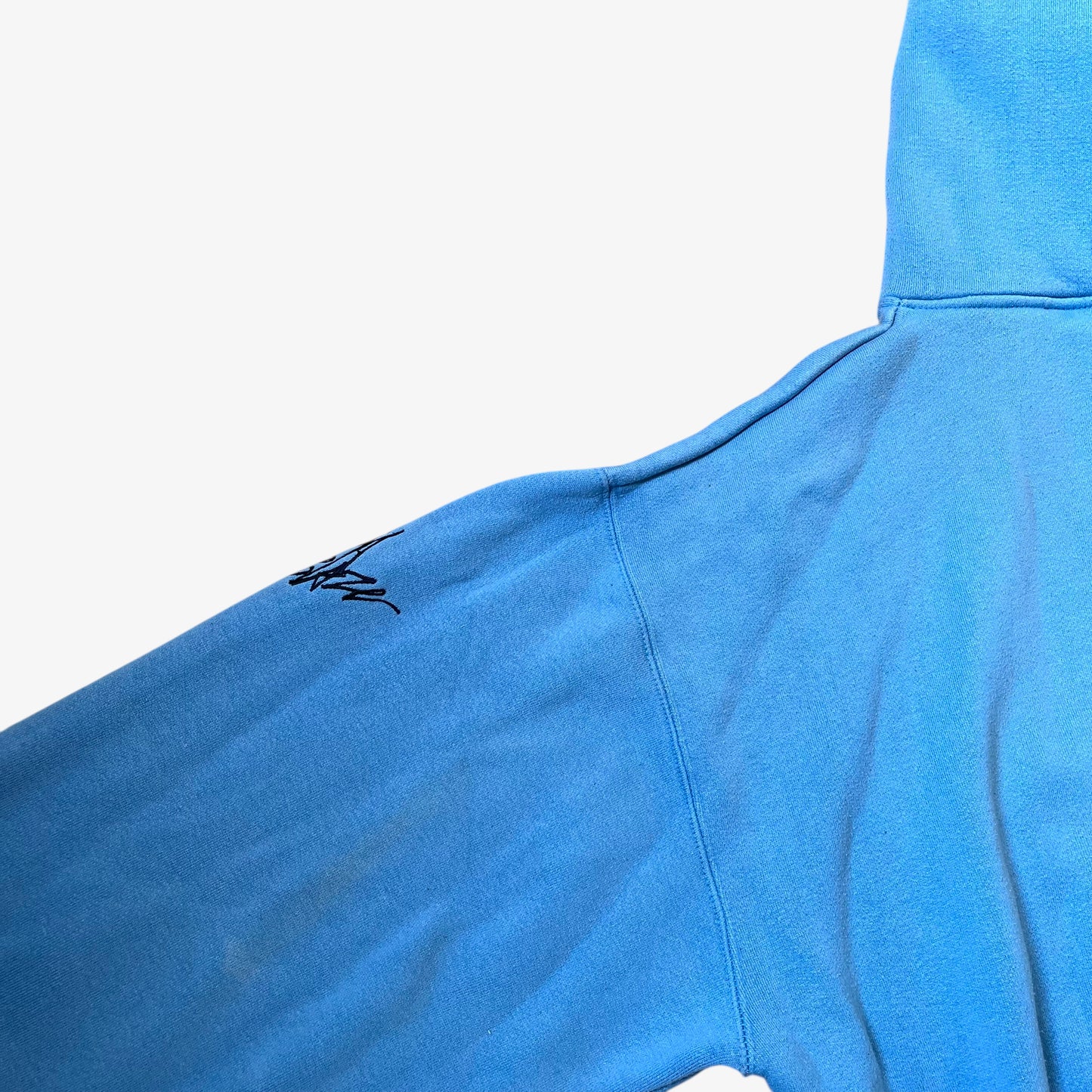 Shoulder of vintage 90s men's Johnny Blaze blue hoodie.